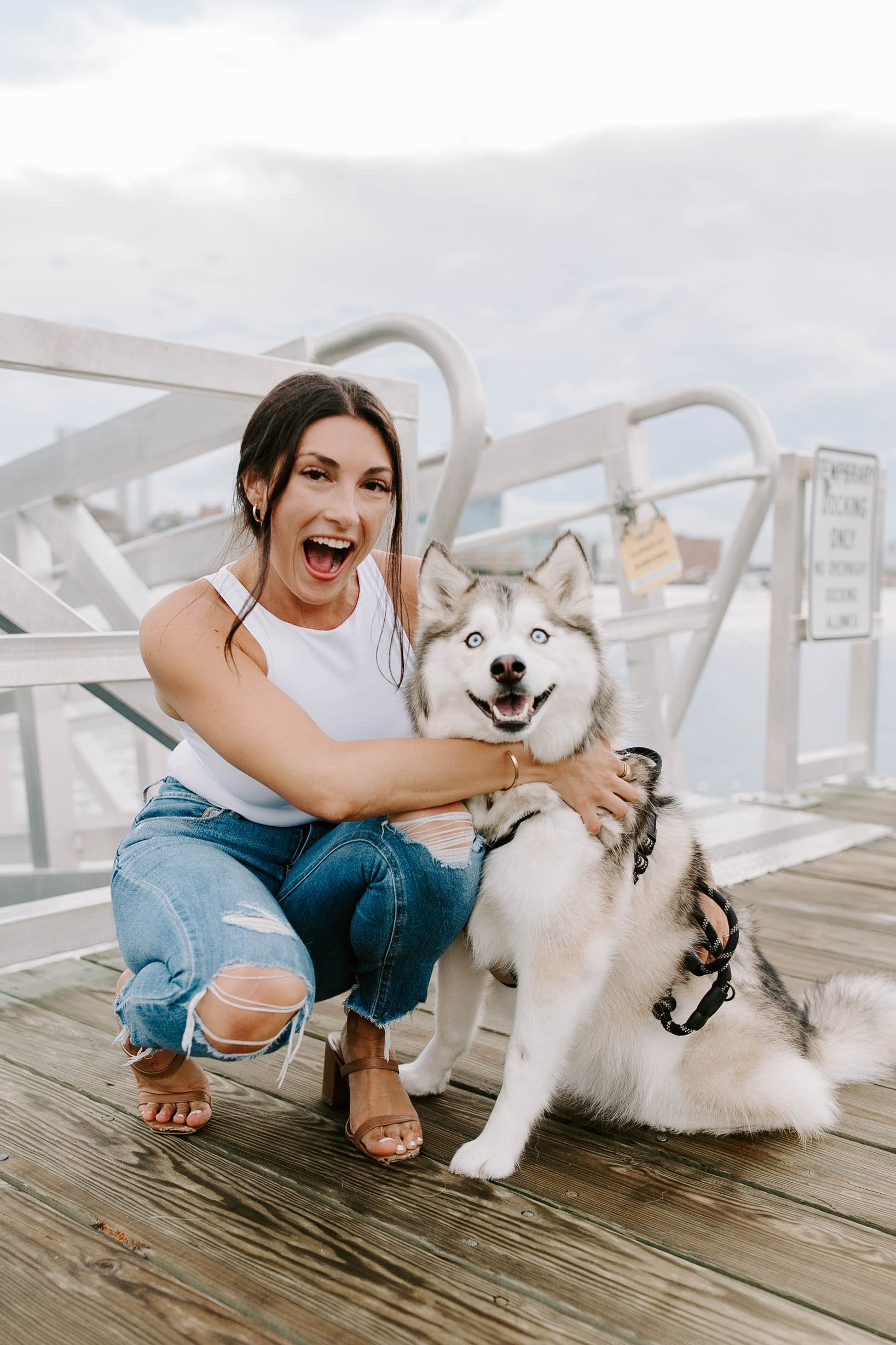  Woman smiling holding husky at Seaport in Boston 