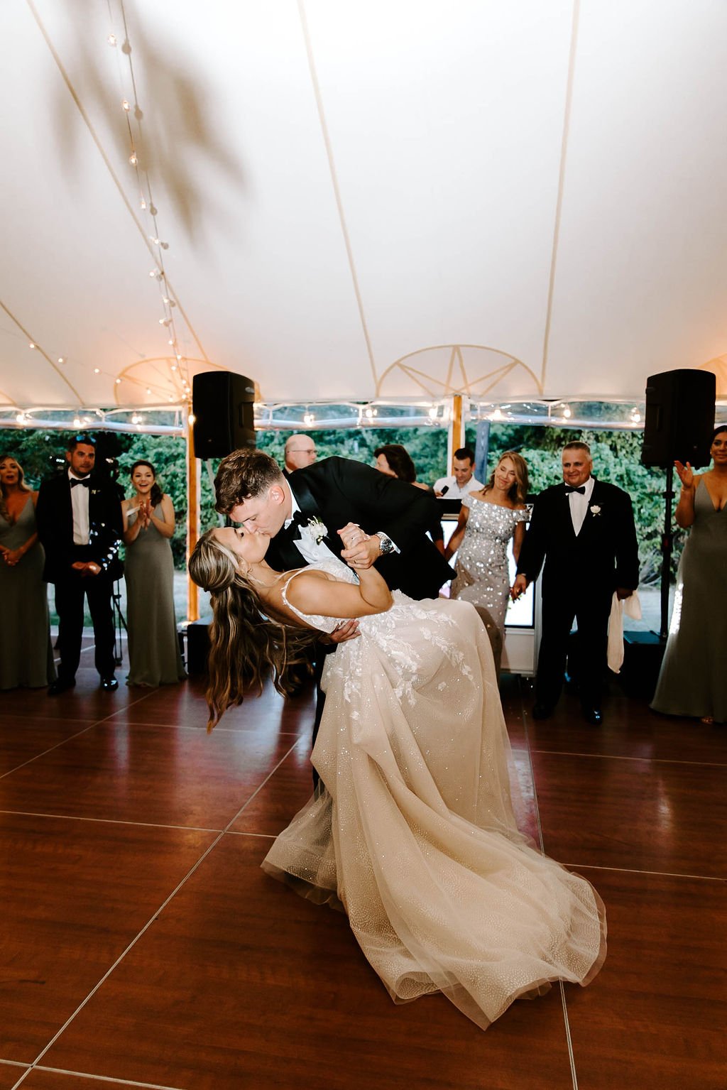 Groom dipping bride on wedding reception dance floor