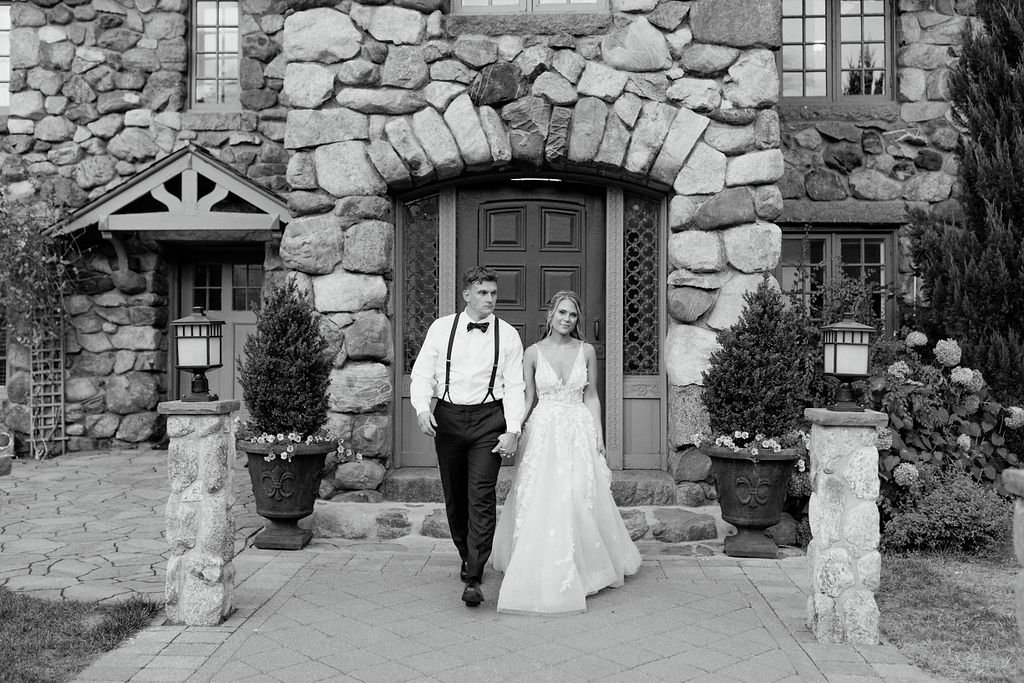 Bride and groom walking in front of Willowdale Estate