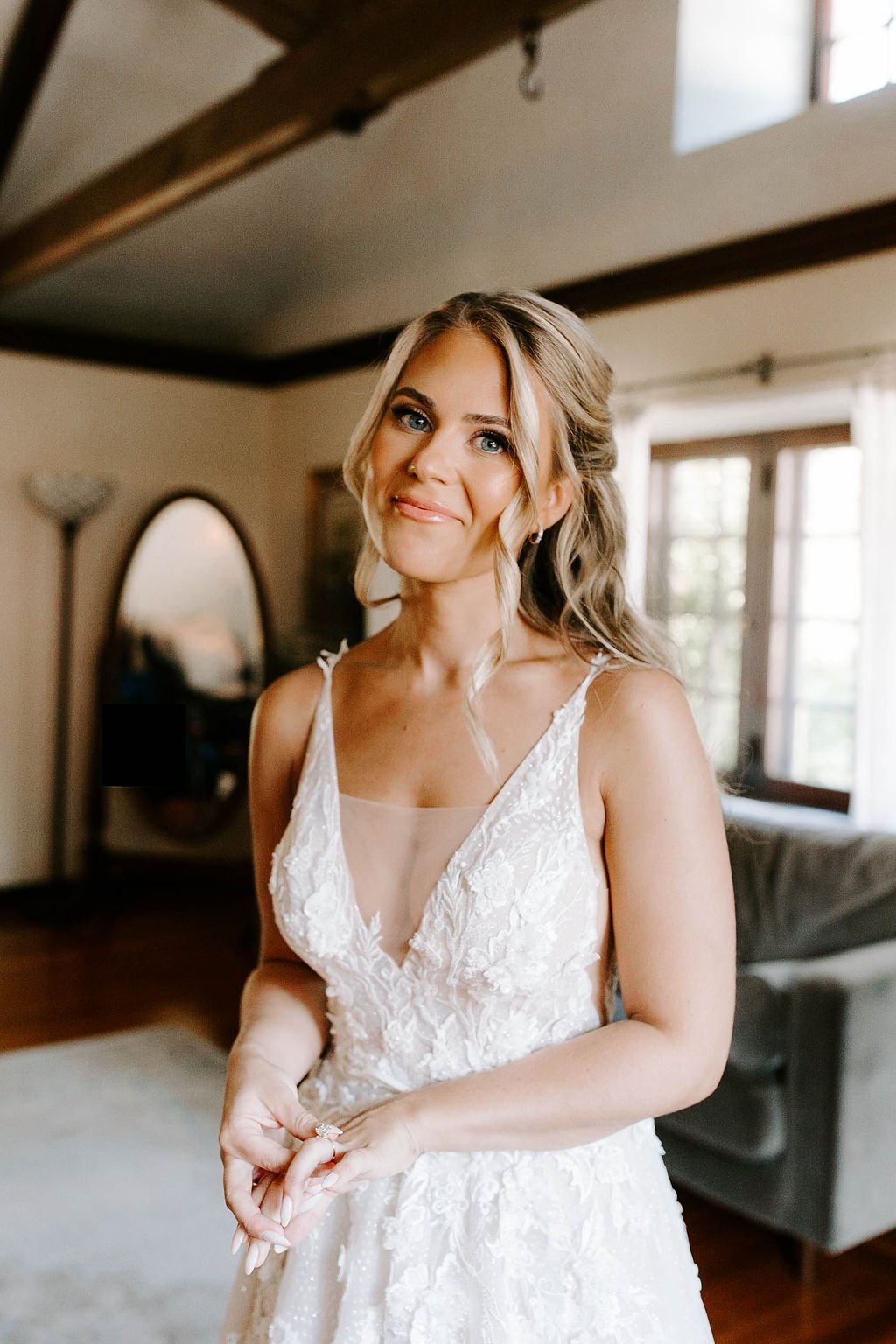 Bride smiling in beautiful lace wedding dress
