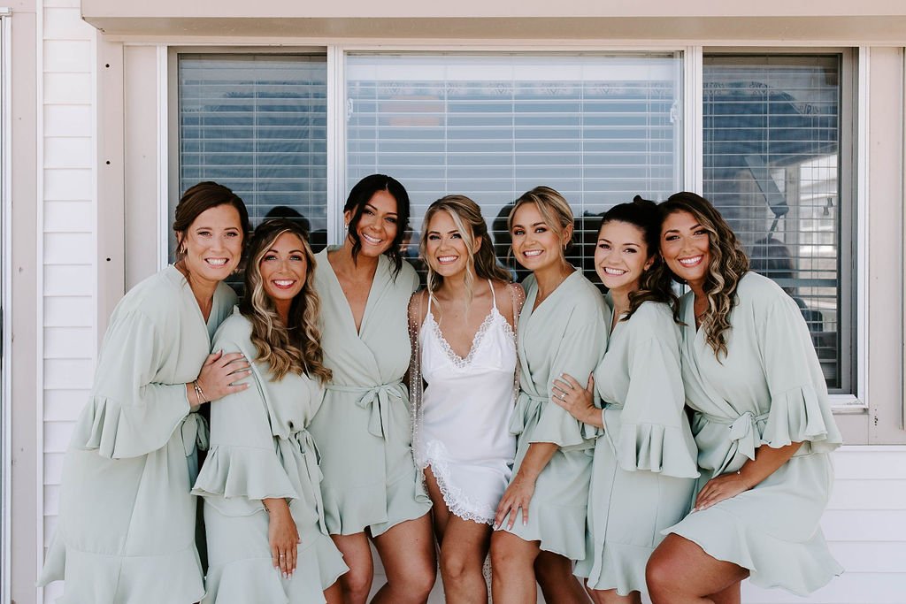Bride and bridesmaids smiling for getting ready portaits