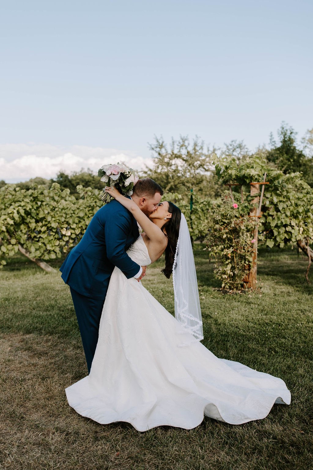  Bride and groom kissing in vineyards   