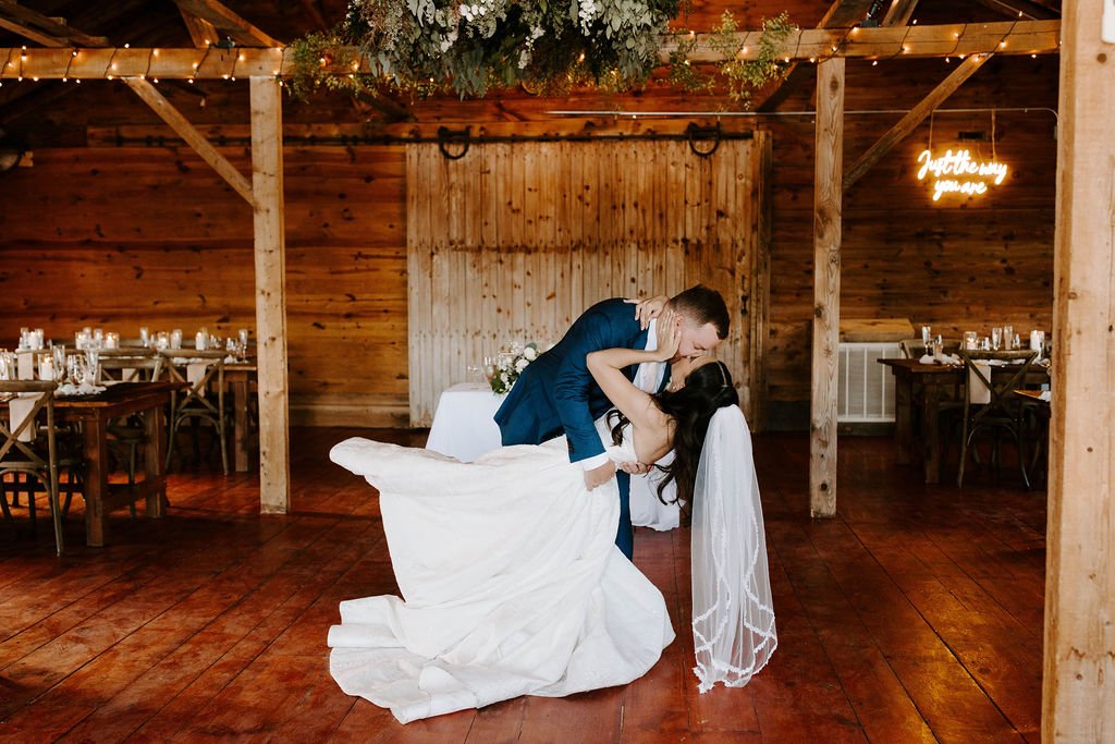 Bride and groom kissing in wedding reception room