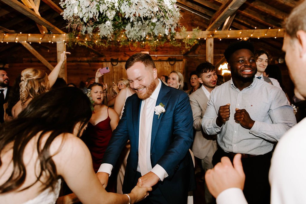 Groom dancing with bride smiling
