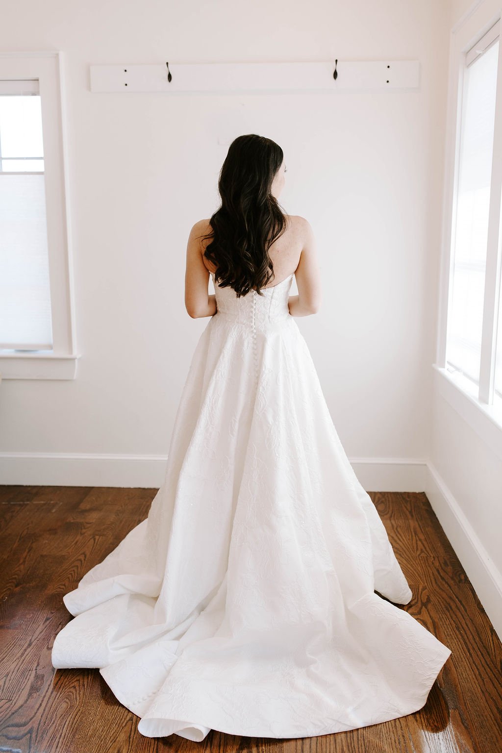 Bride facing wall in a ball gown wedding dress
