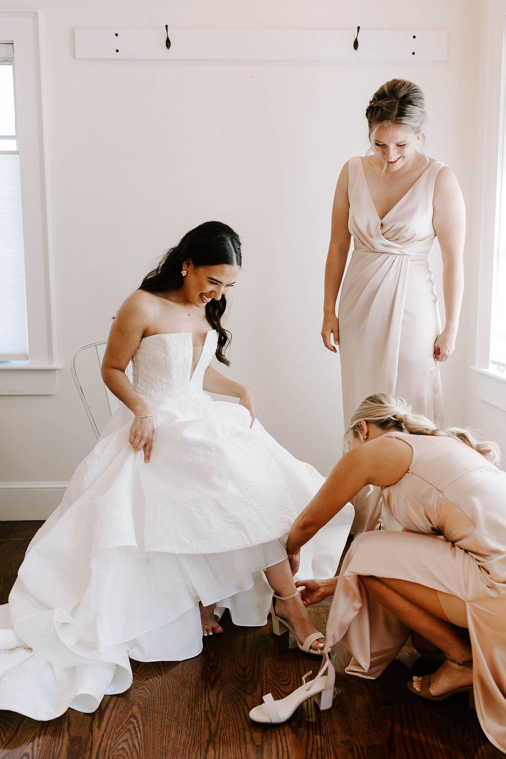 Bride getting ready with bridesmaids for her barn wedding