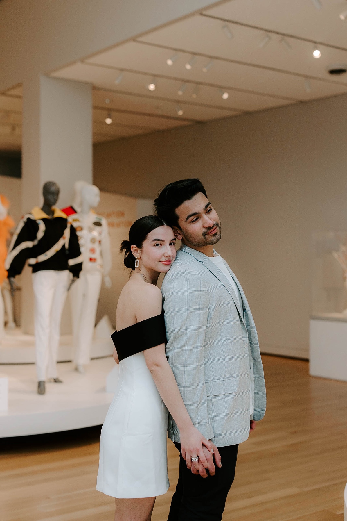 Man and woman pose in exhibit at Essex Peabody Museum