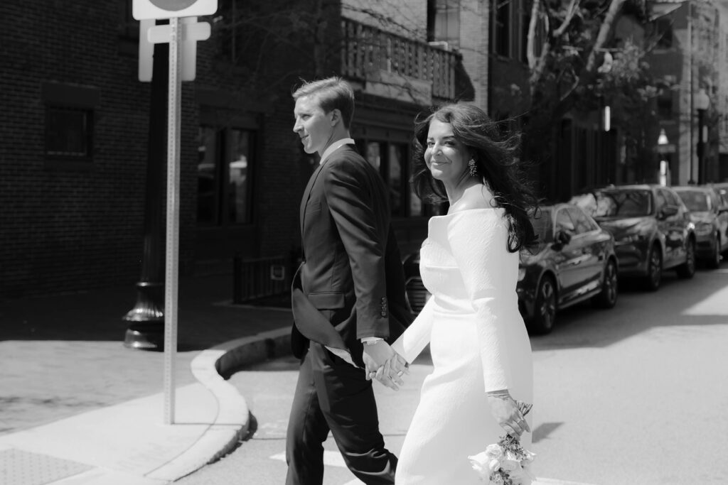 Bride and groom walk to their elopement at the Boston Public Library