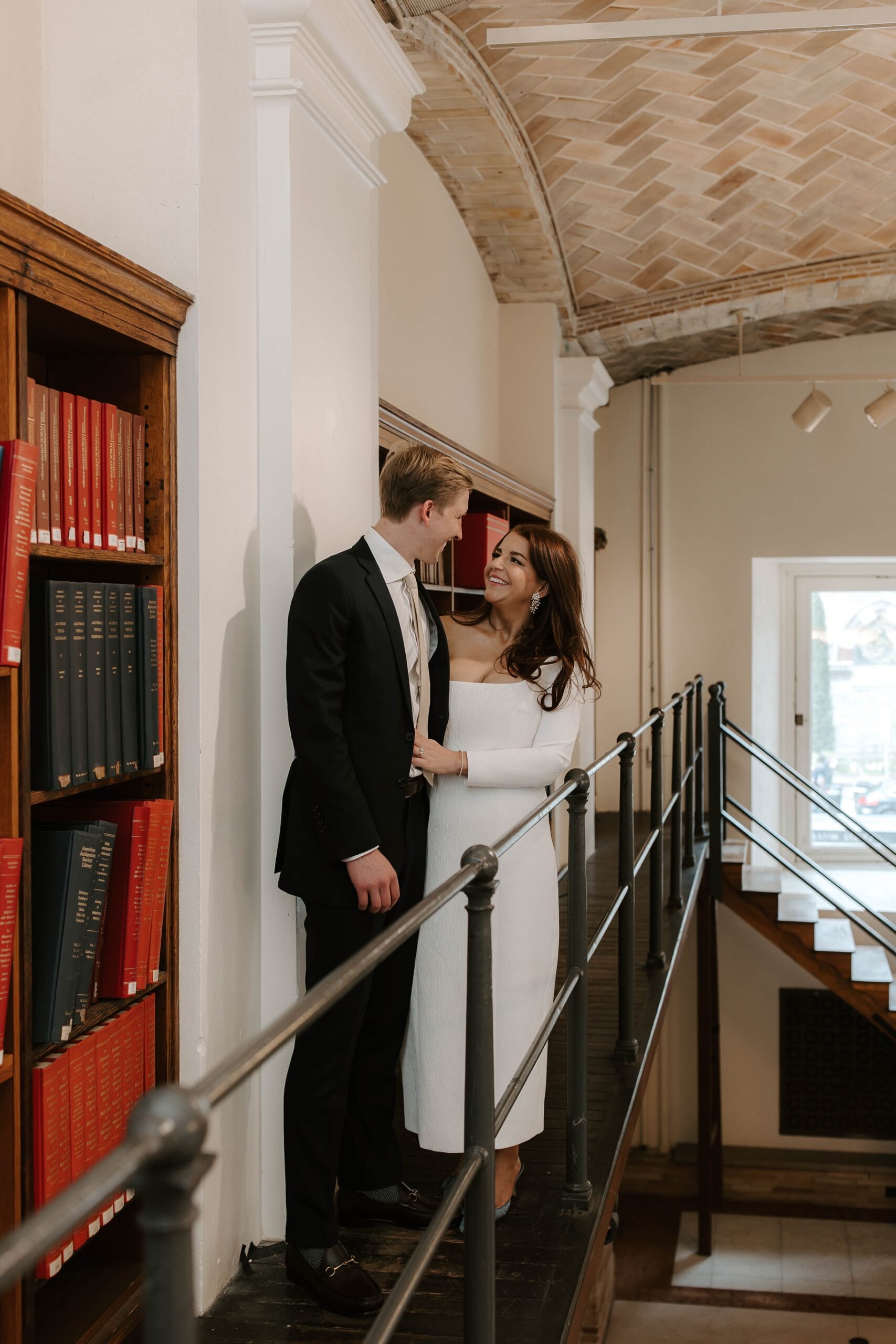 Bride and groom pose with the books at their Boston Public Library elopement
