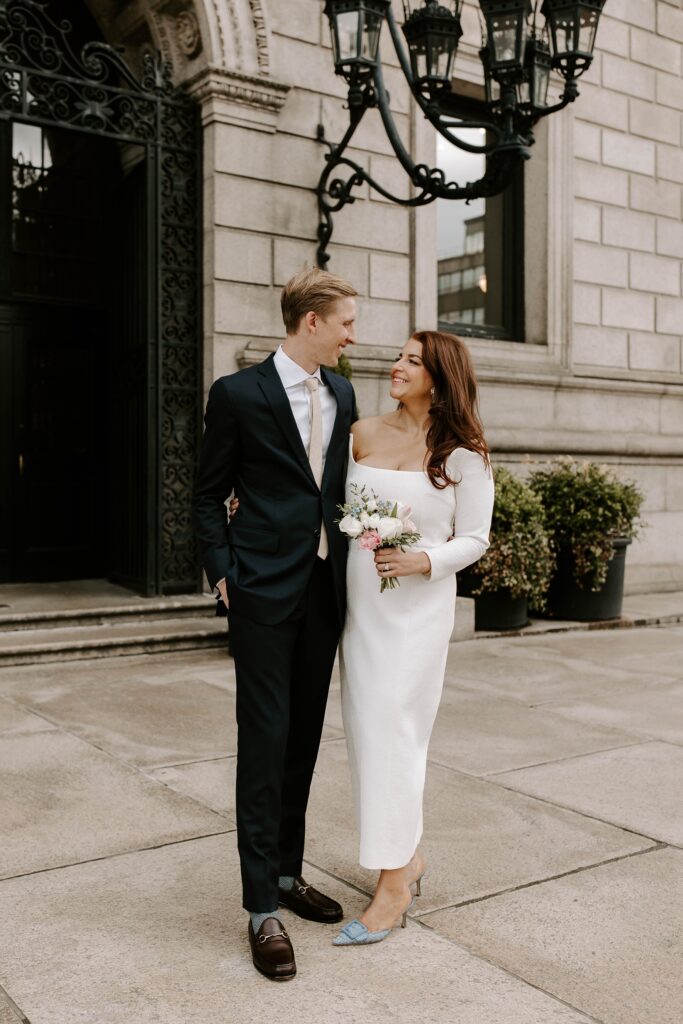 Bride and groom smile at each other before their Boston elopement