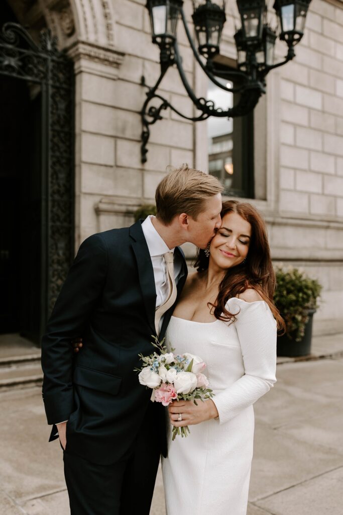 Groom kissed bride on the cheek before Boston elopement