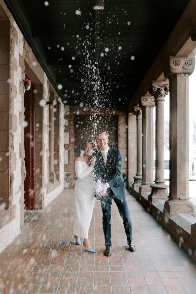 Brie and groom pop champagne after Boston Public Library elopement