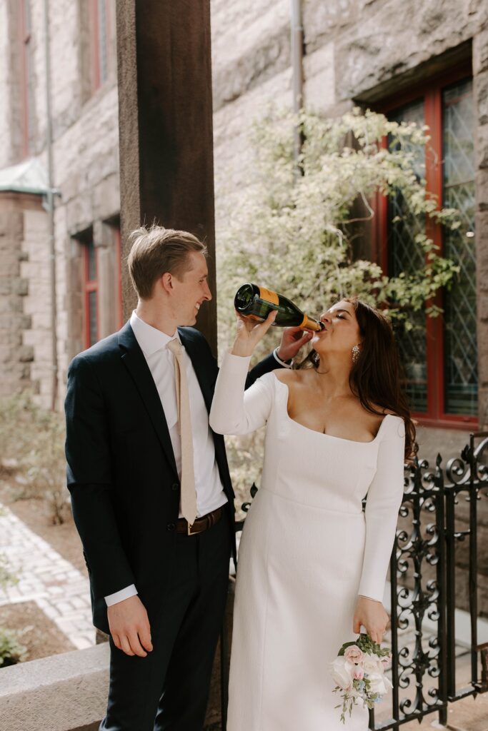 Bride sips champagne after Boston Public Library elopement