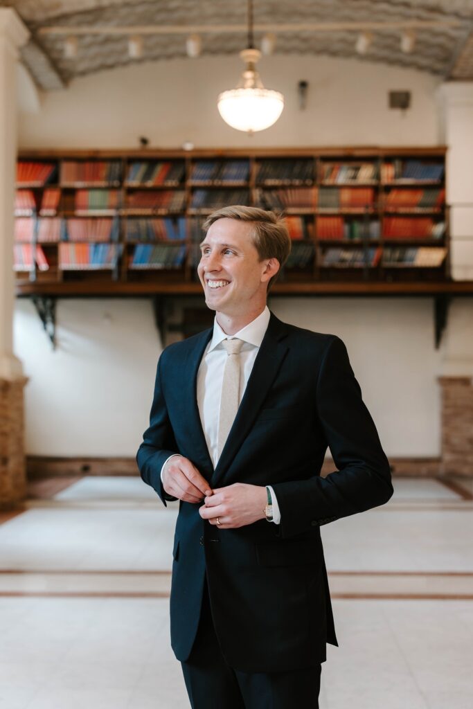 Groom smiles at his Boston Public Library elopement