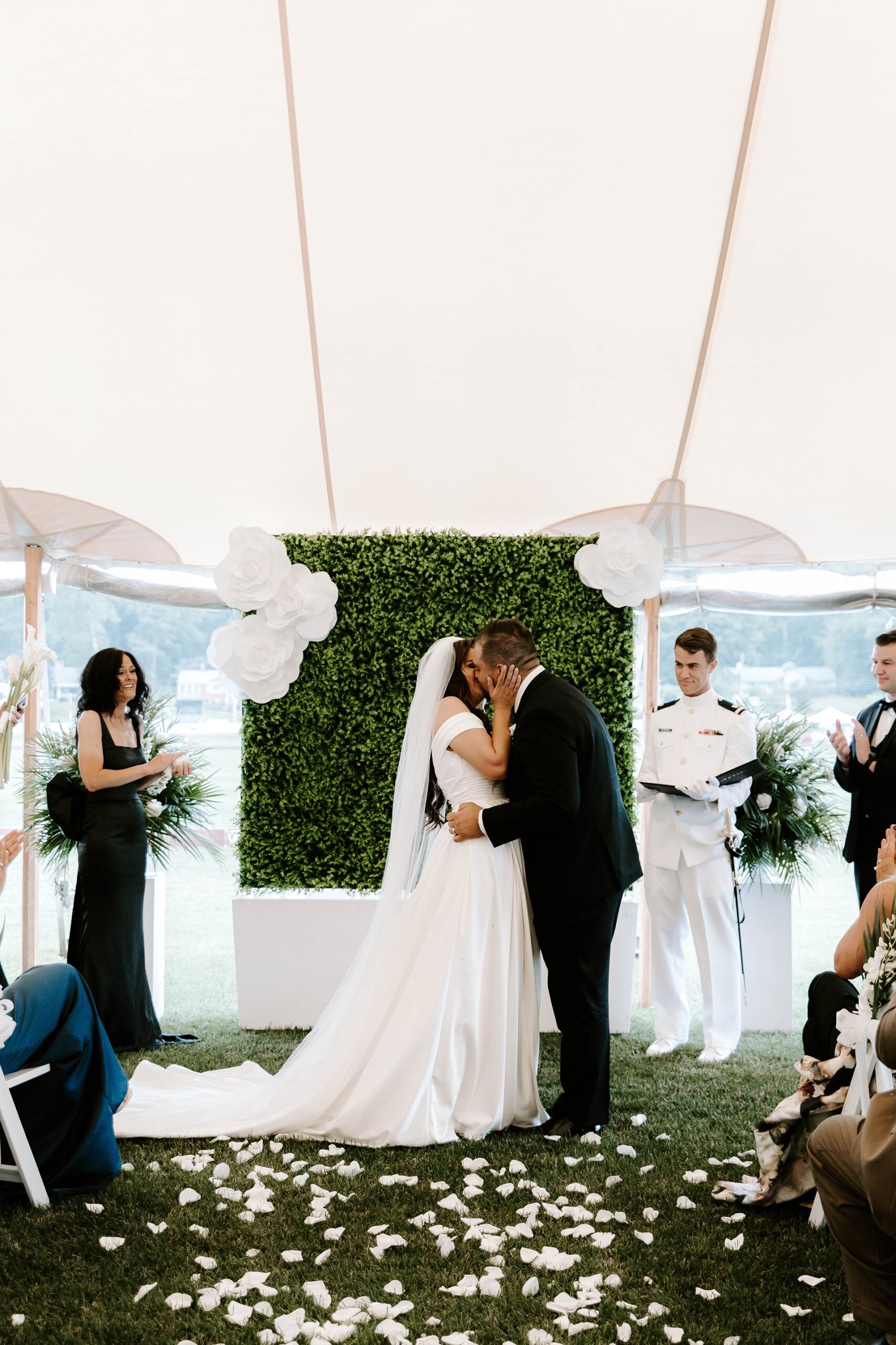 Bride and groom kiss at Farmington Polo Club wedding ceremony
