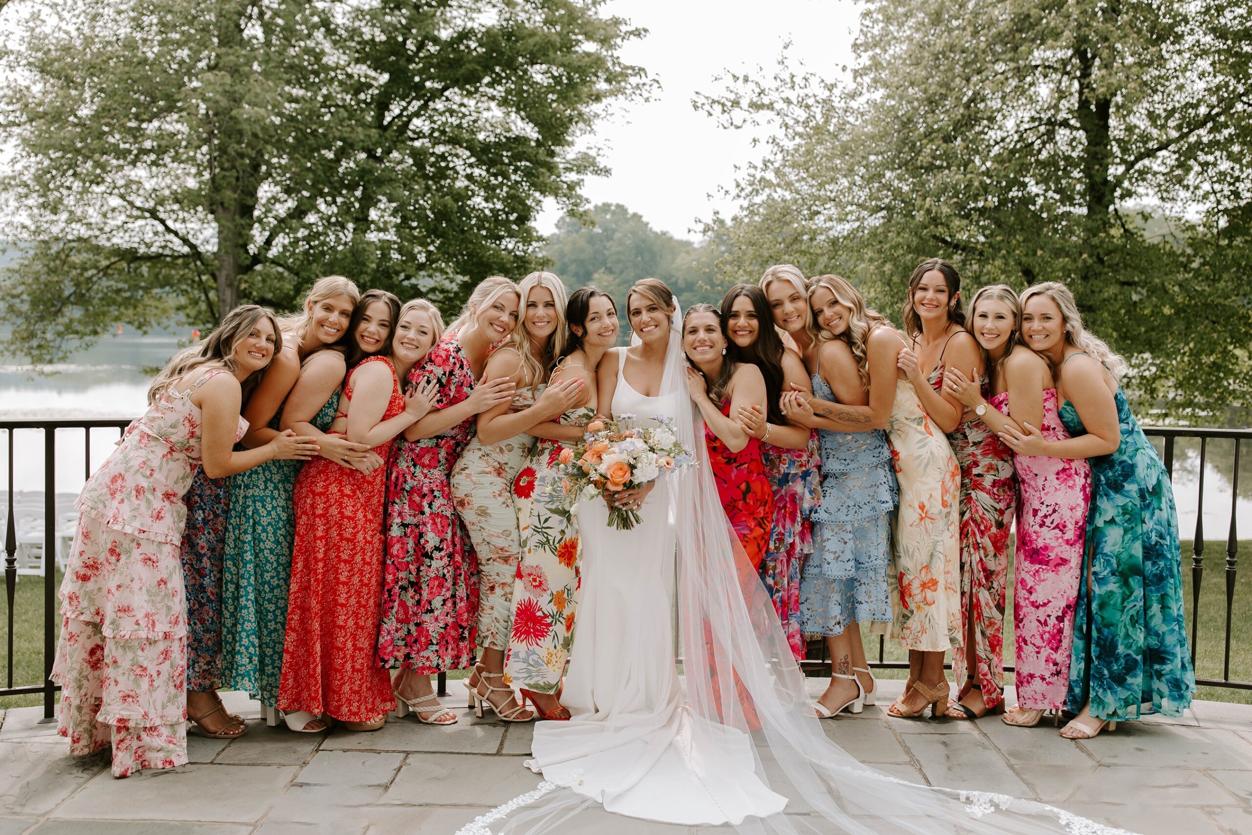 Bride poses with bridesmaids in colorful dresses