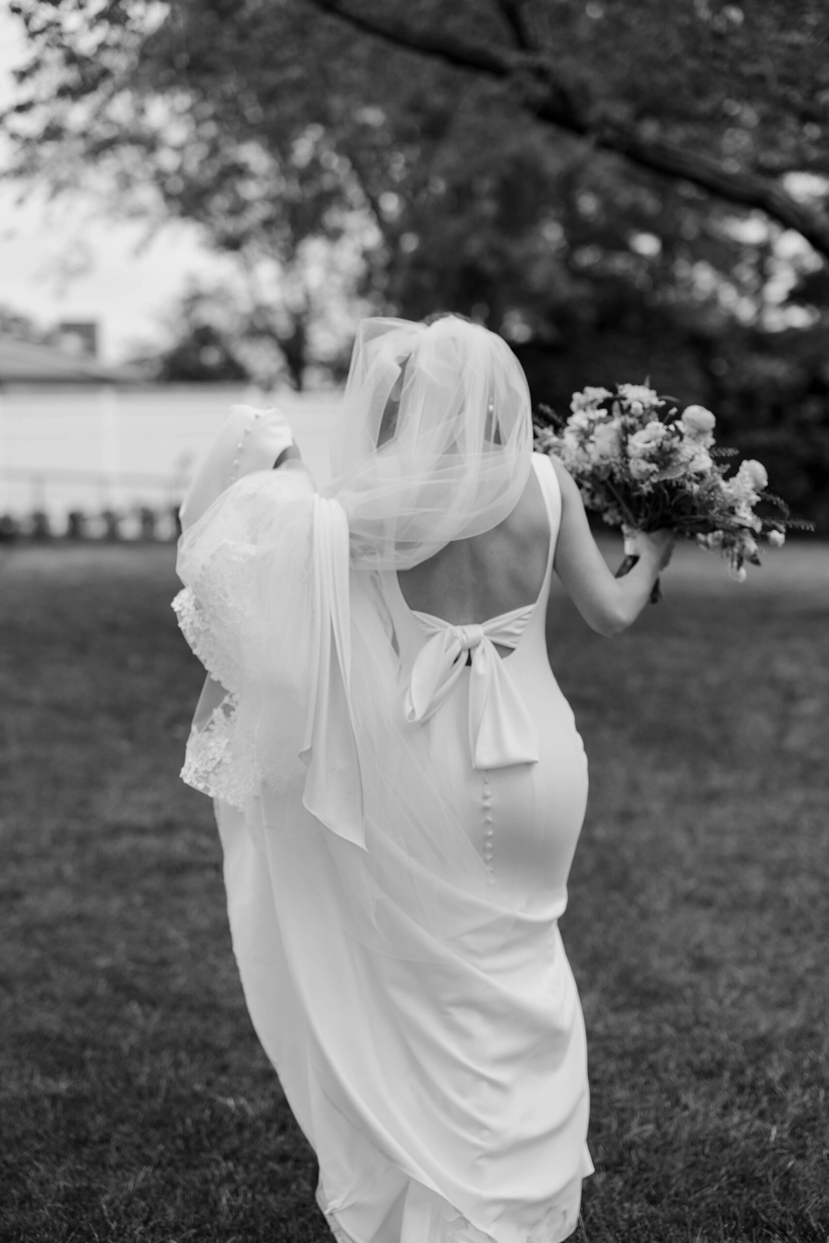 Bride walks to the outdoor ceremony space at the Indian Trail Club wedding