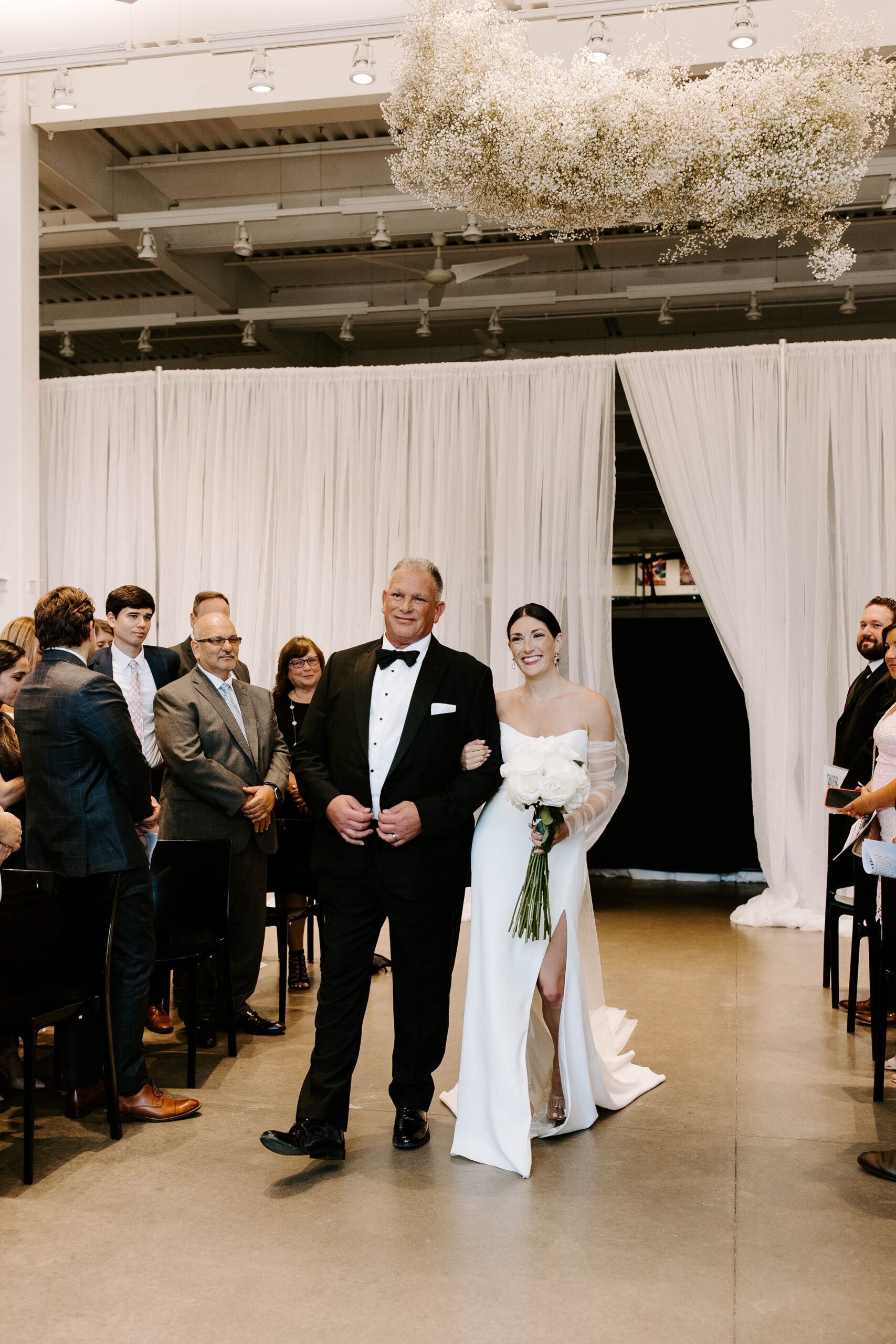 Bride walks down the aisle with water at Artists for Humanity Epicenter wedding