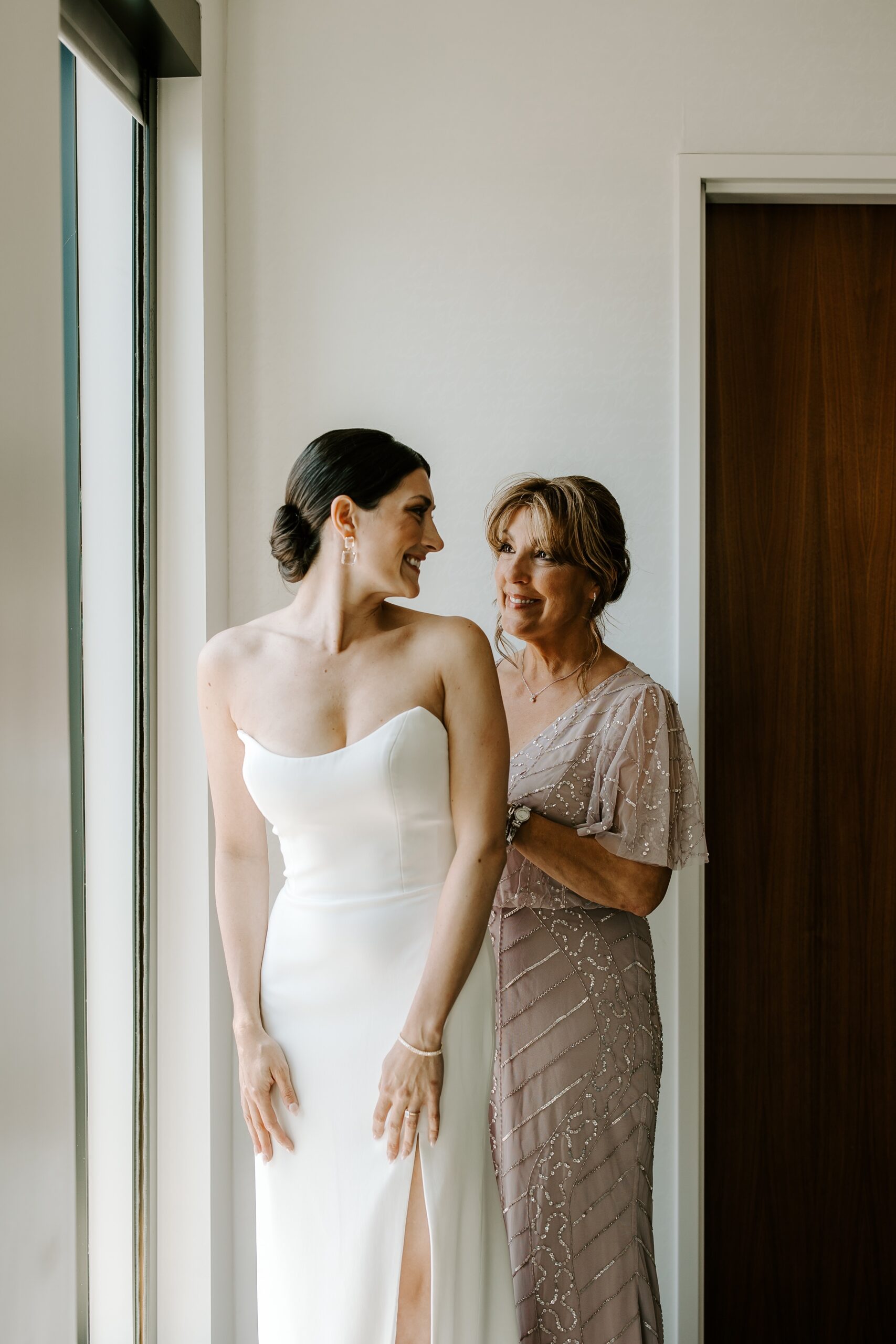 Bride gets into wedding dress with mother's help