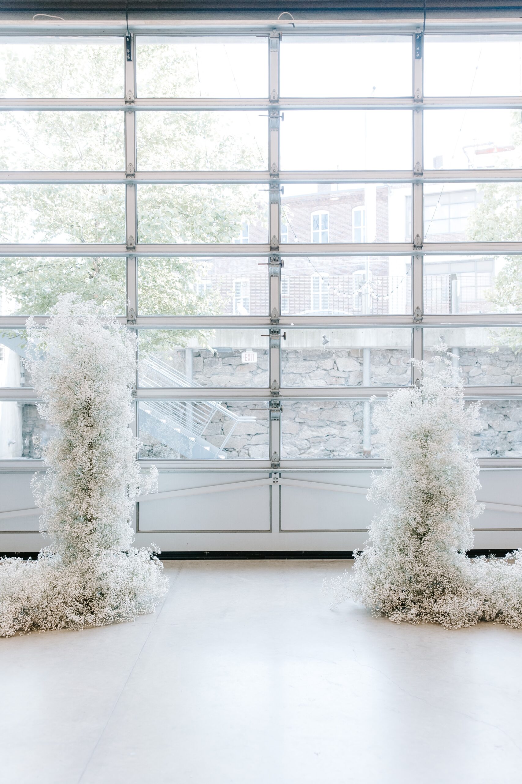 Baby's breath arch at Artists for Humanity Epicenter wedding ceremony