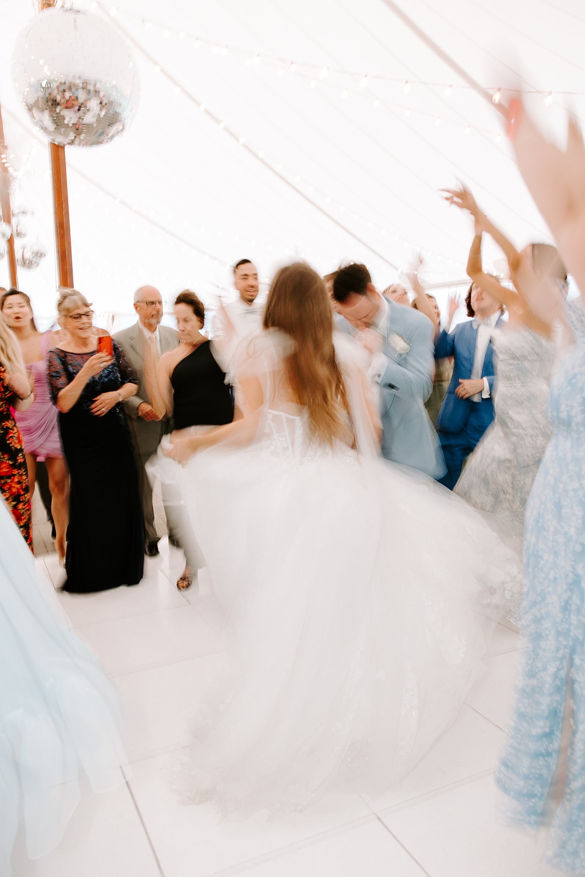 Bride and groom dance with guests at their Estate at Moraine Farm wedding