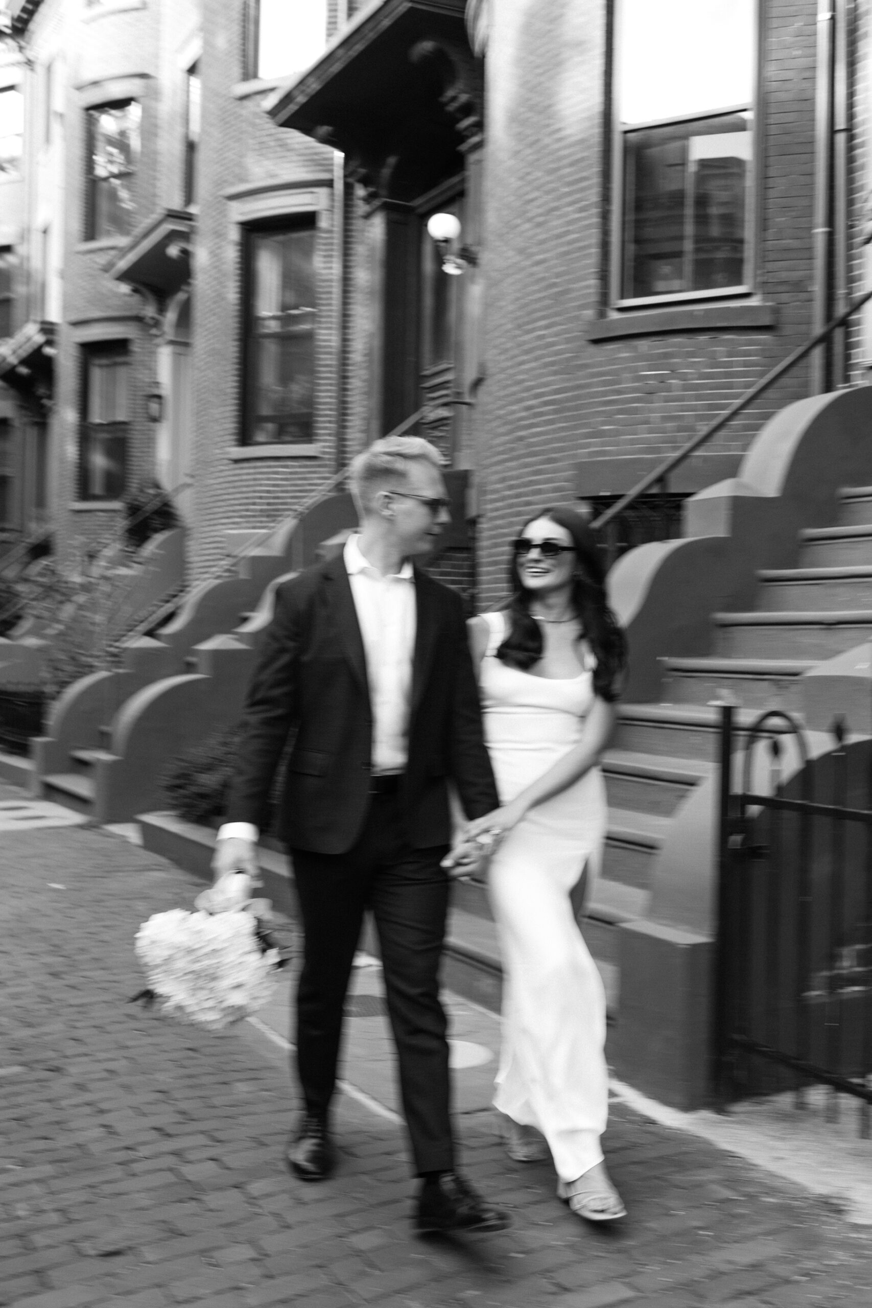 Bride and groom walk in Boston