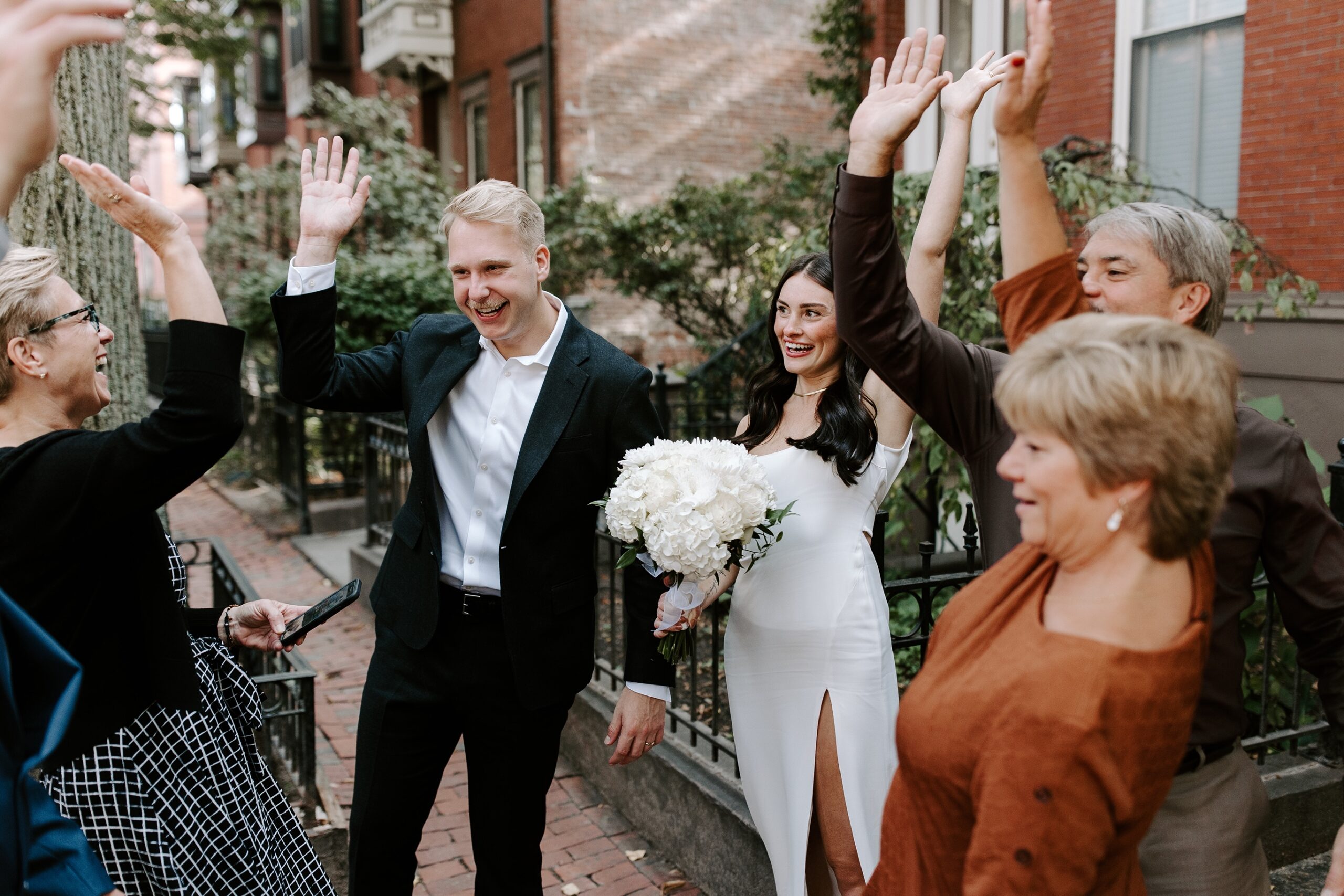 Couple has fun with family at Boston elopement
