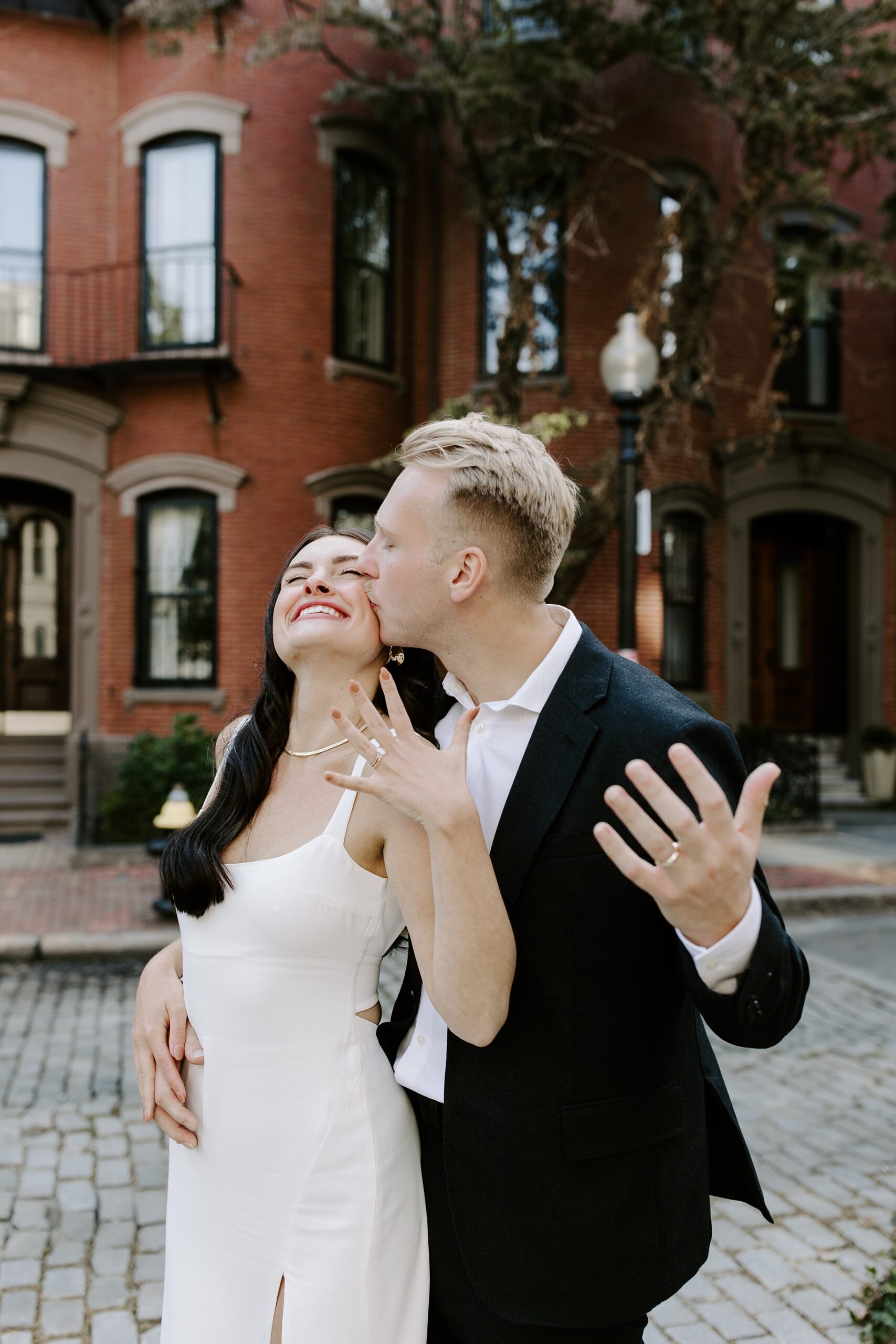 Groom kisses bride on cheek at Boston elopement