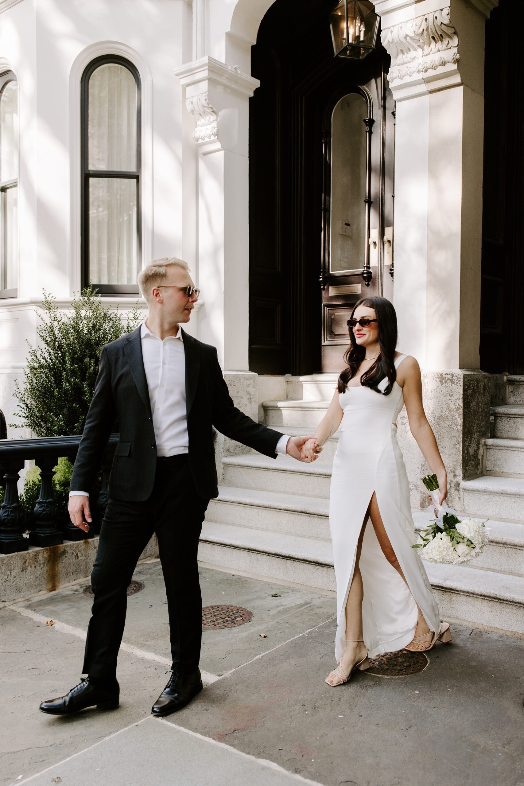 Bride and groom hold hands after their Boston elopement