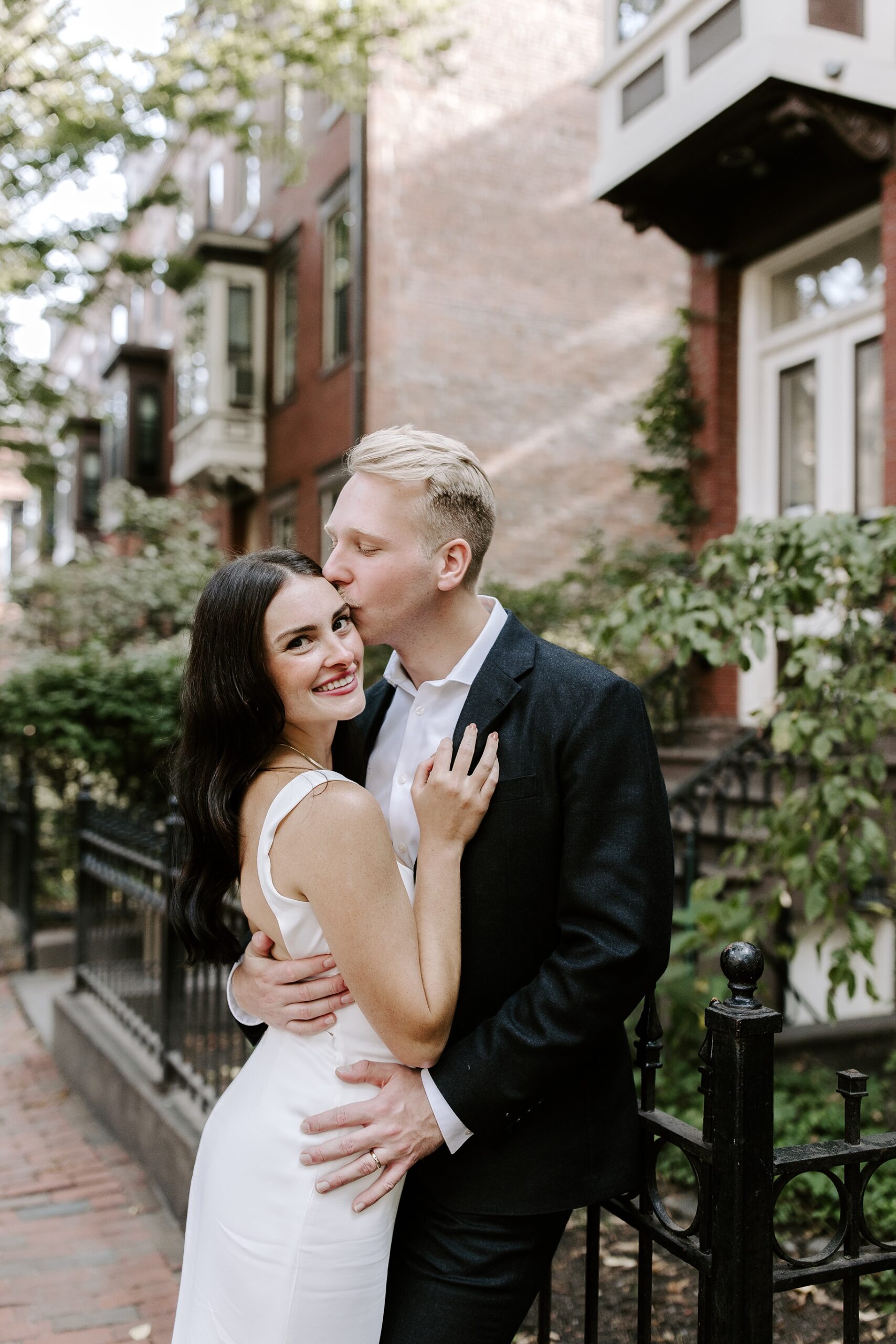 Groom kisses bride at Boston elopement