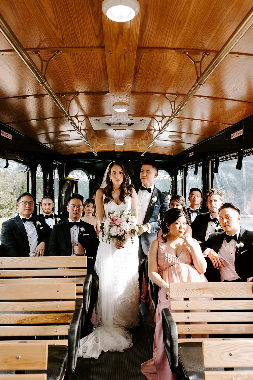 Bride and groom with wedding party on trolley