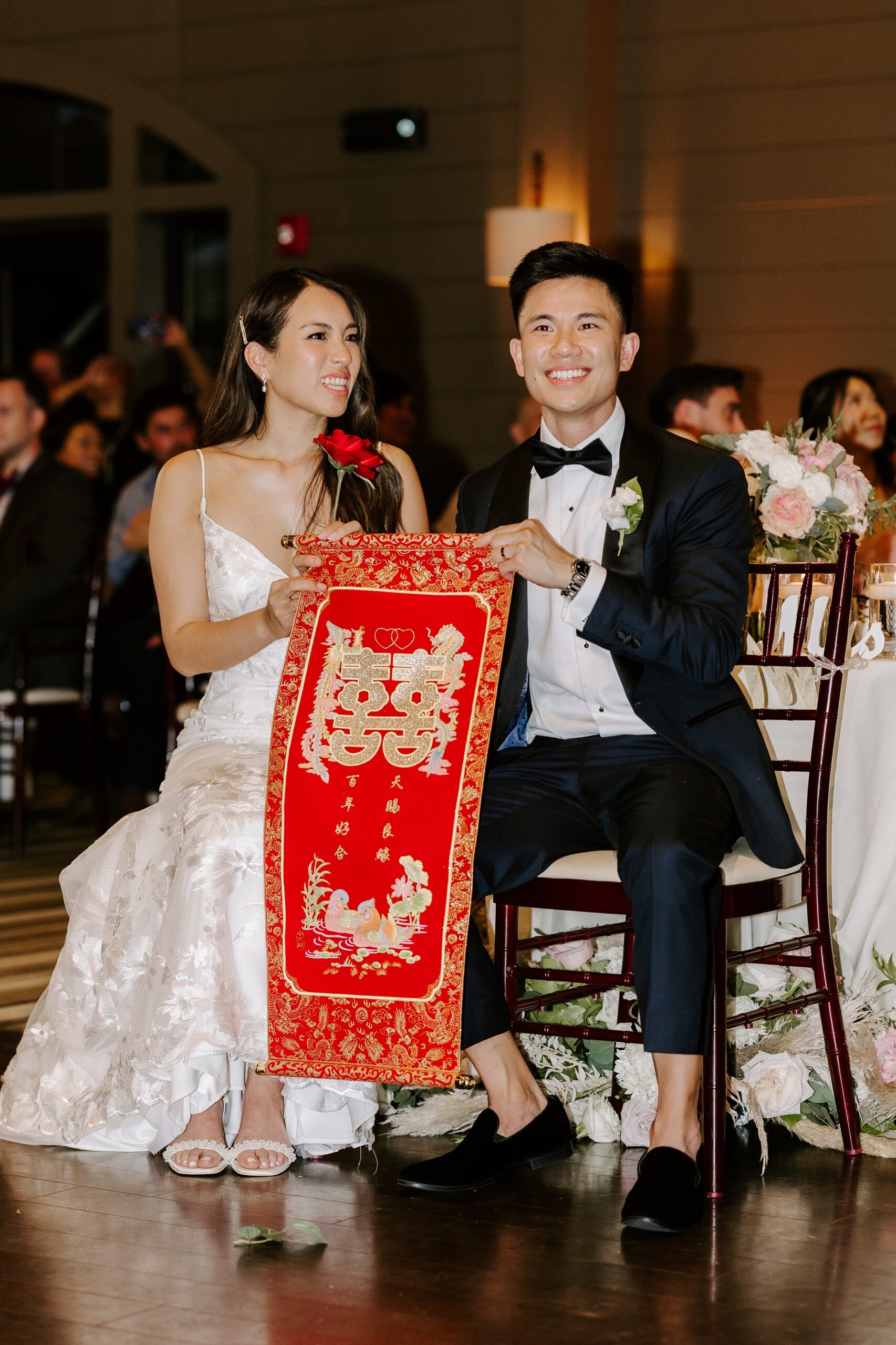 Bride and groom watch the Lion Dance