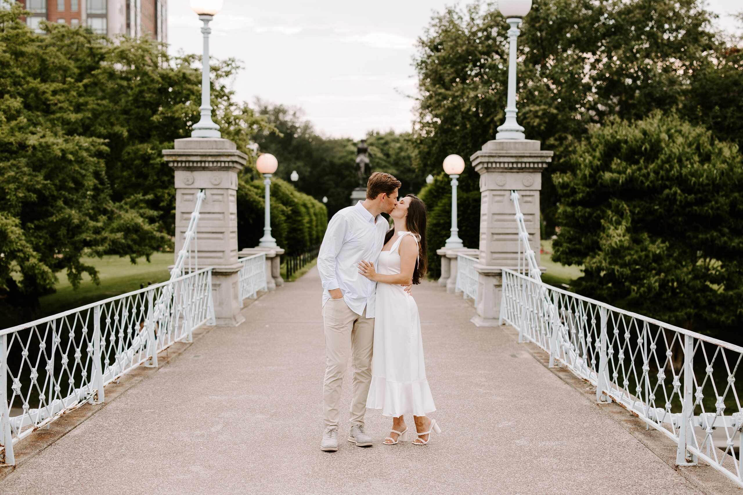 Couple kisses on bridge in Boston Common