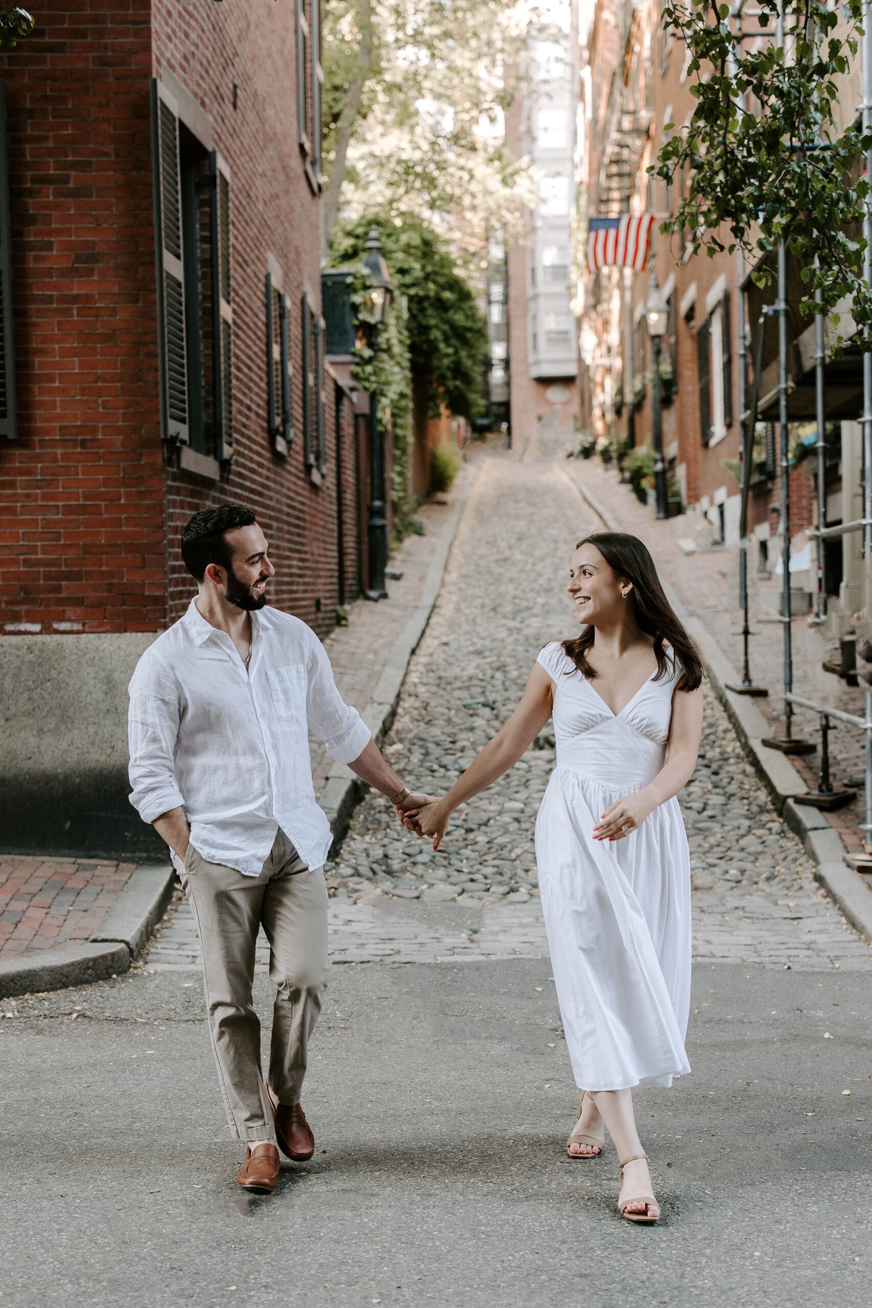 Boston couple walks during Boston engagement photos