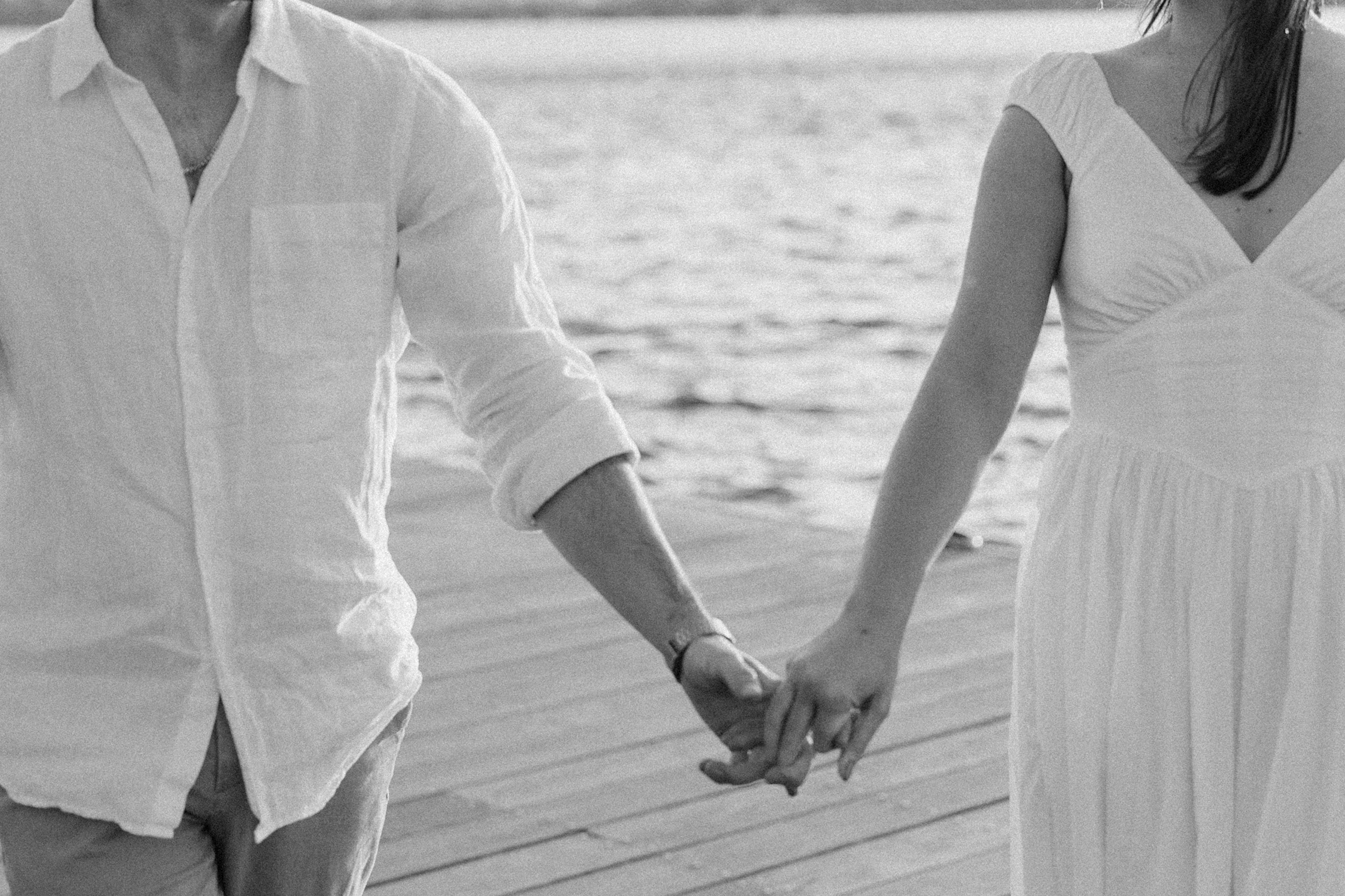 Man and woman hold hands during Boston Esplanade engagement session