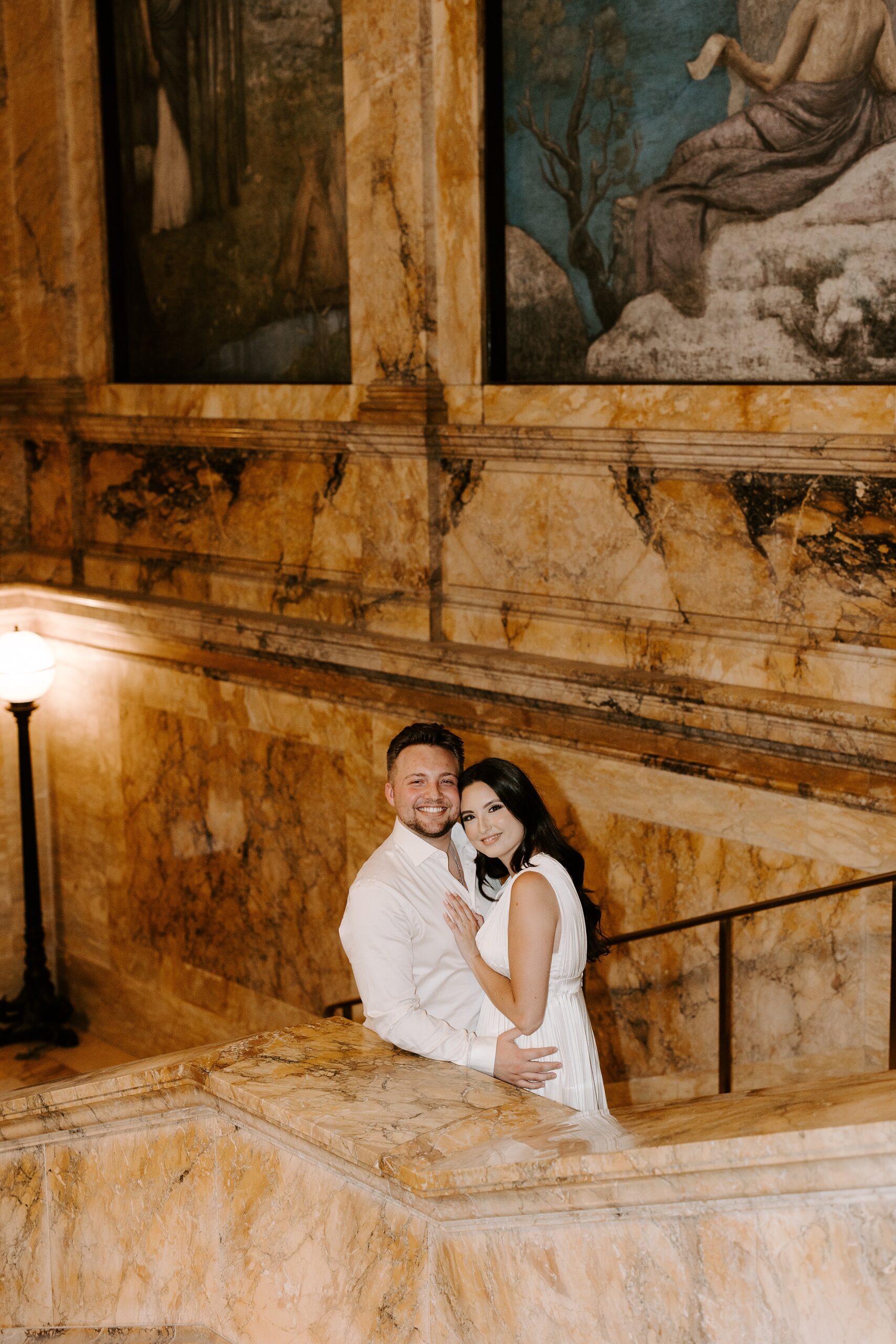 Man and woman smile at camera during Boston Public Library engagement session