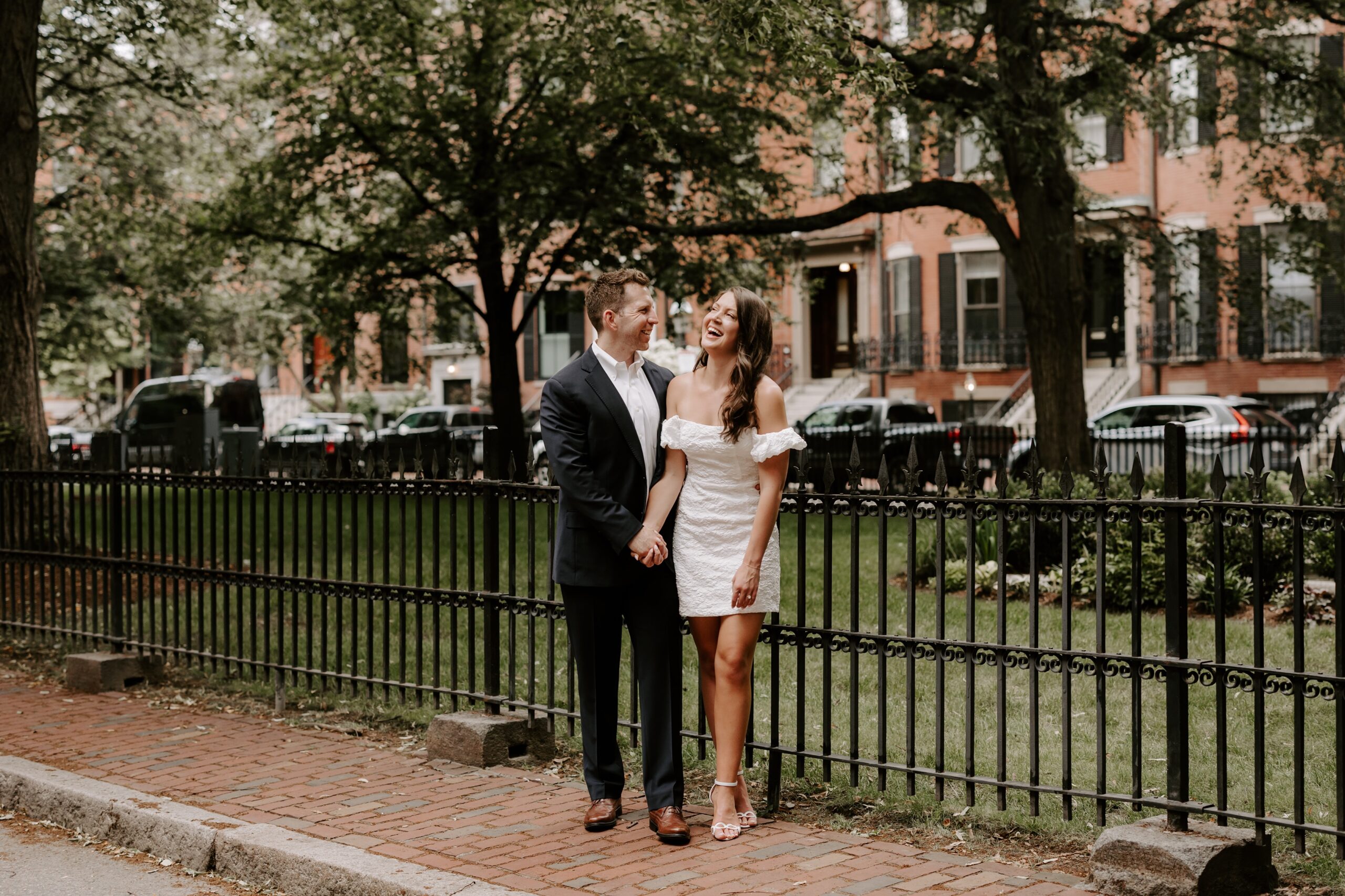 Couple smiles at each other during South End engagement photos