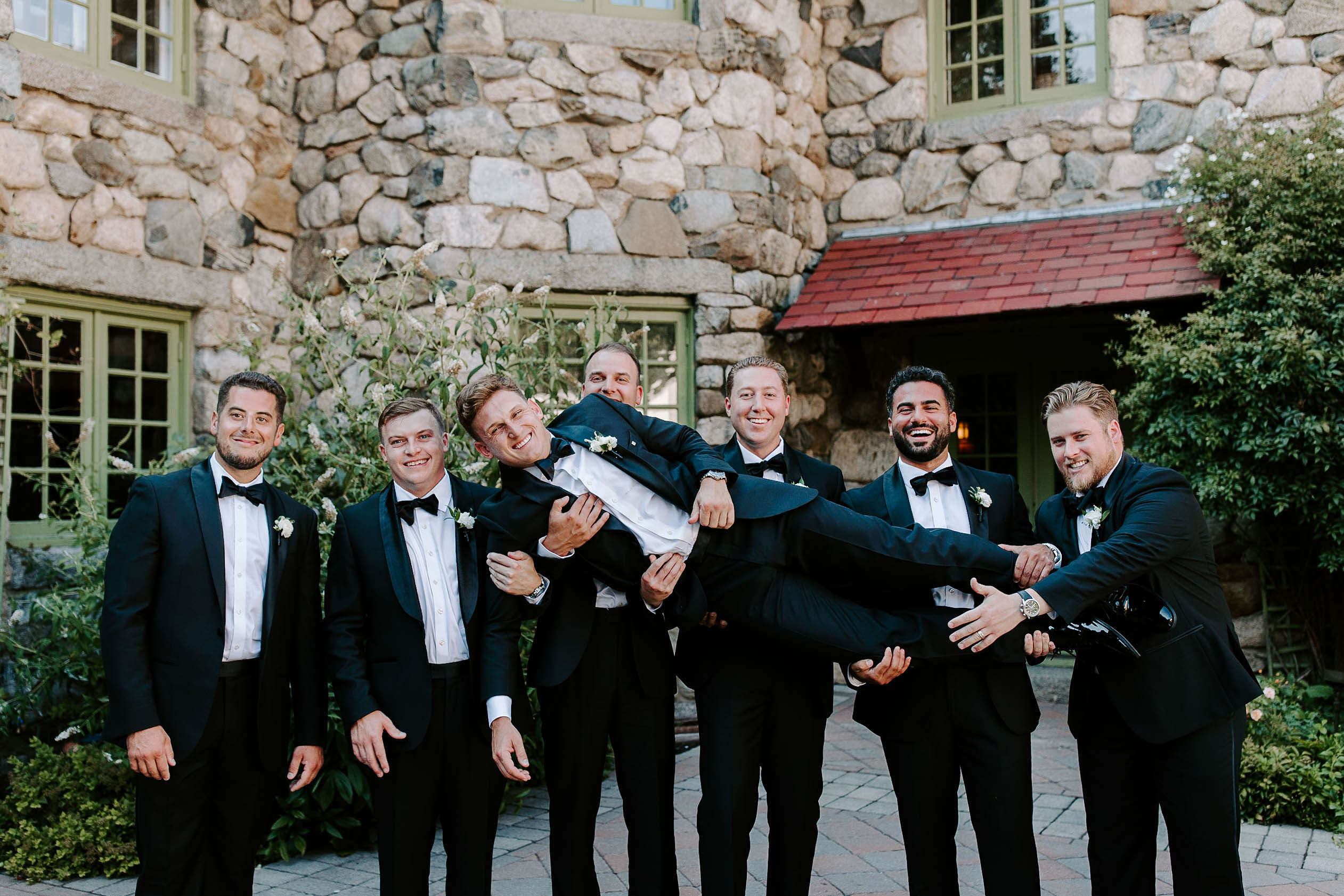 Groom poses with his handsome groomsmen outside his dreamy Boston wedding