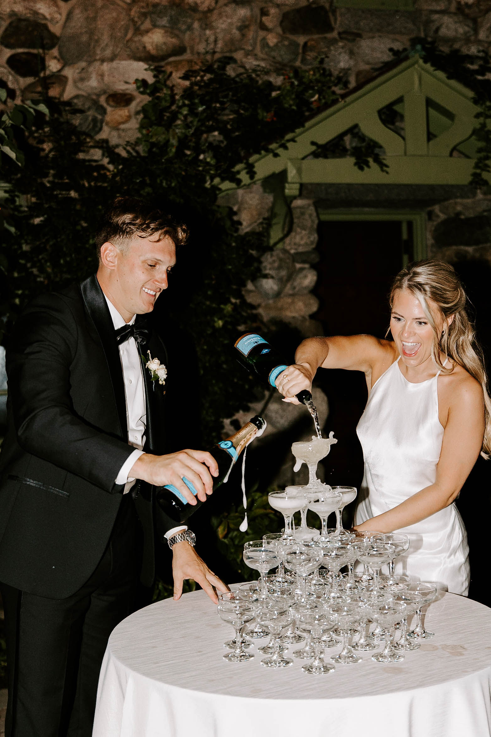 Beautiful bride and groom fill up the champagne tower during their dreamy Boston wedding day 