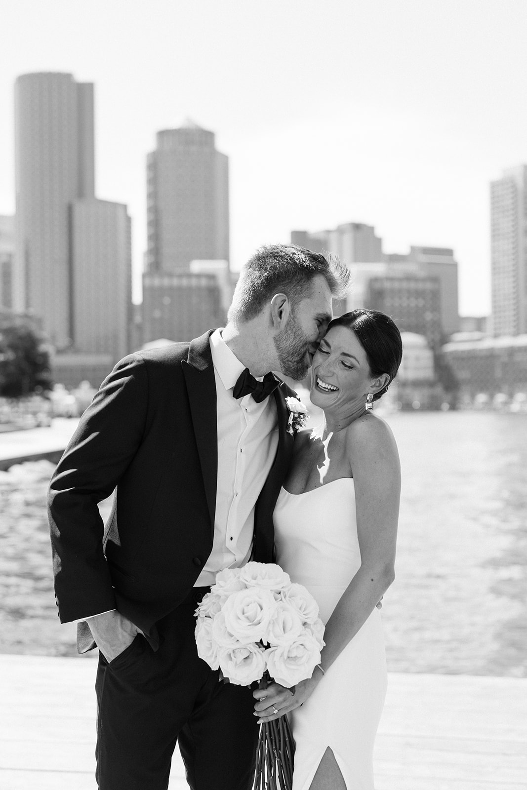 Gorgeous bride and groom pose on the docks 
