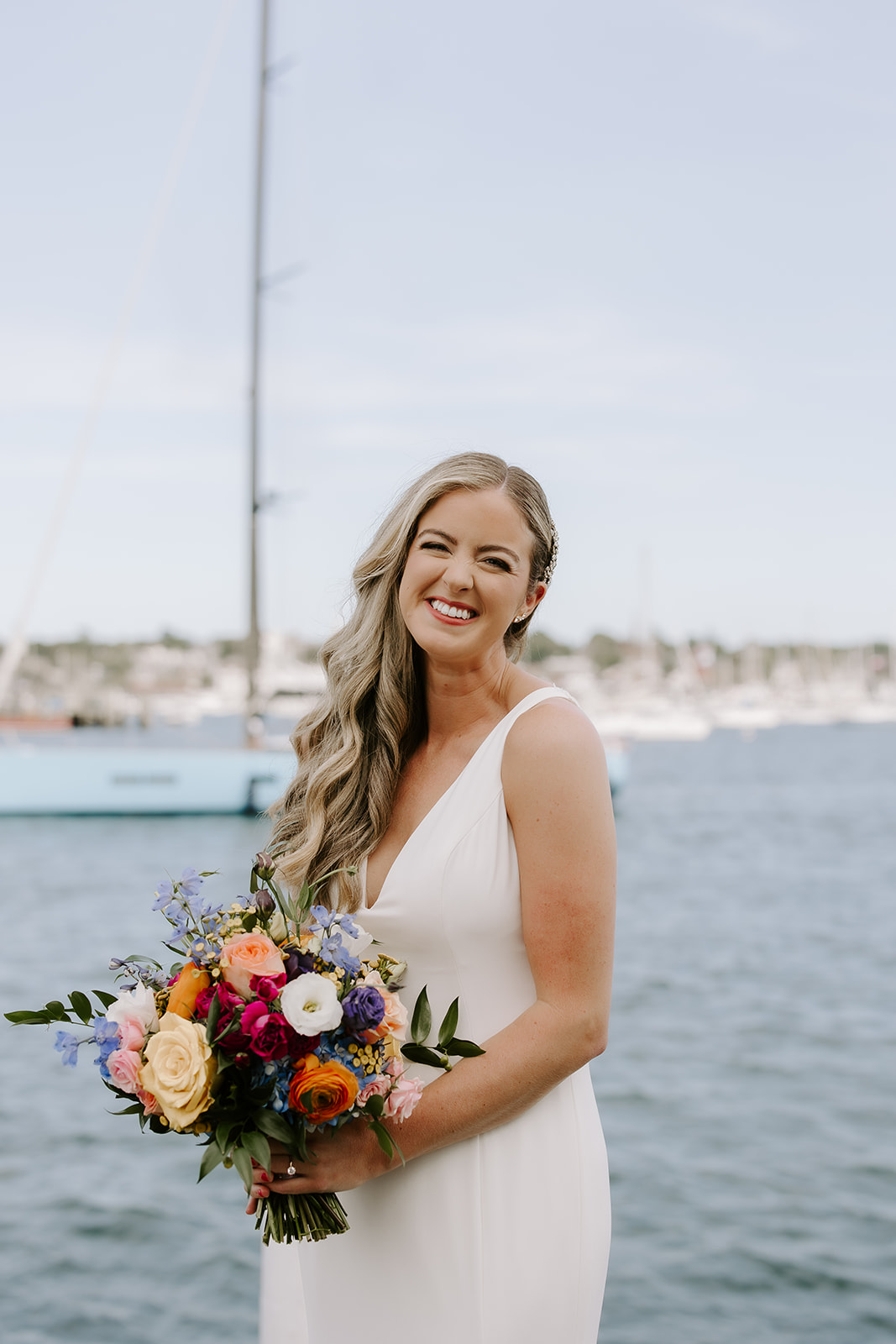 Beautiful bride poses with the sea in the background