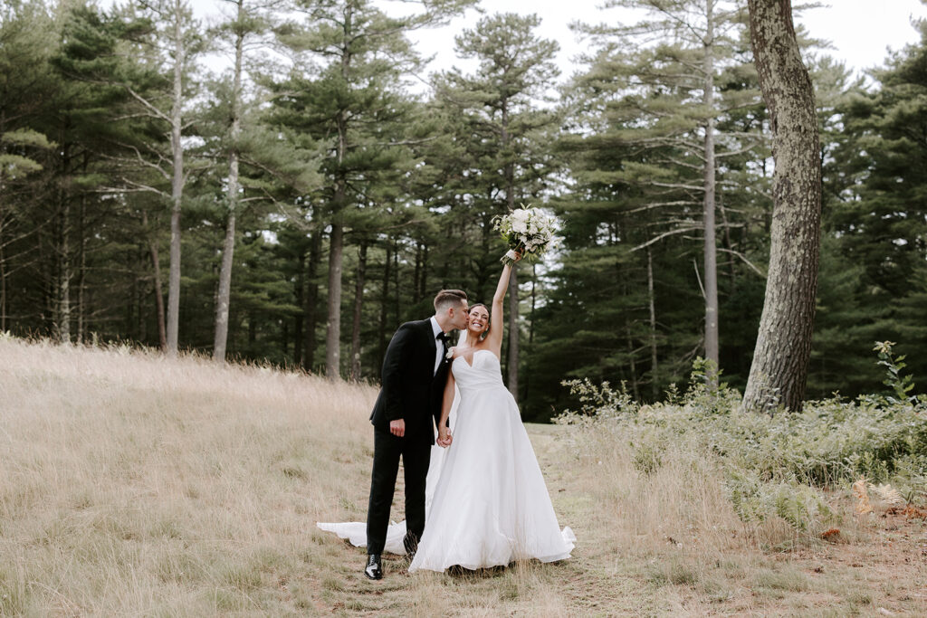 Beautiful bride and groom pose in nature after their stunning wedding