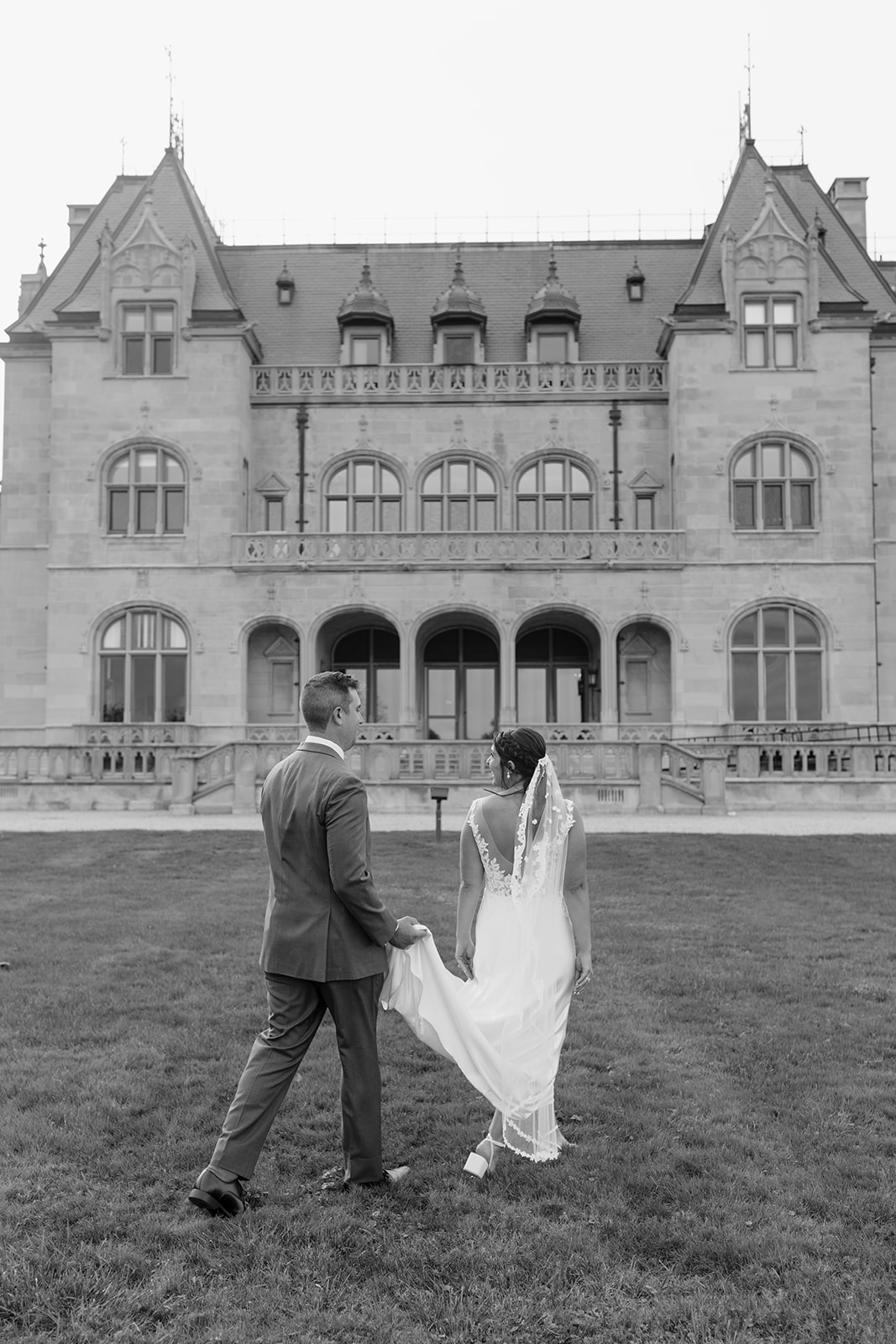 Gorgeous bride and groom pose outside their dreamy New England wedding venue
