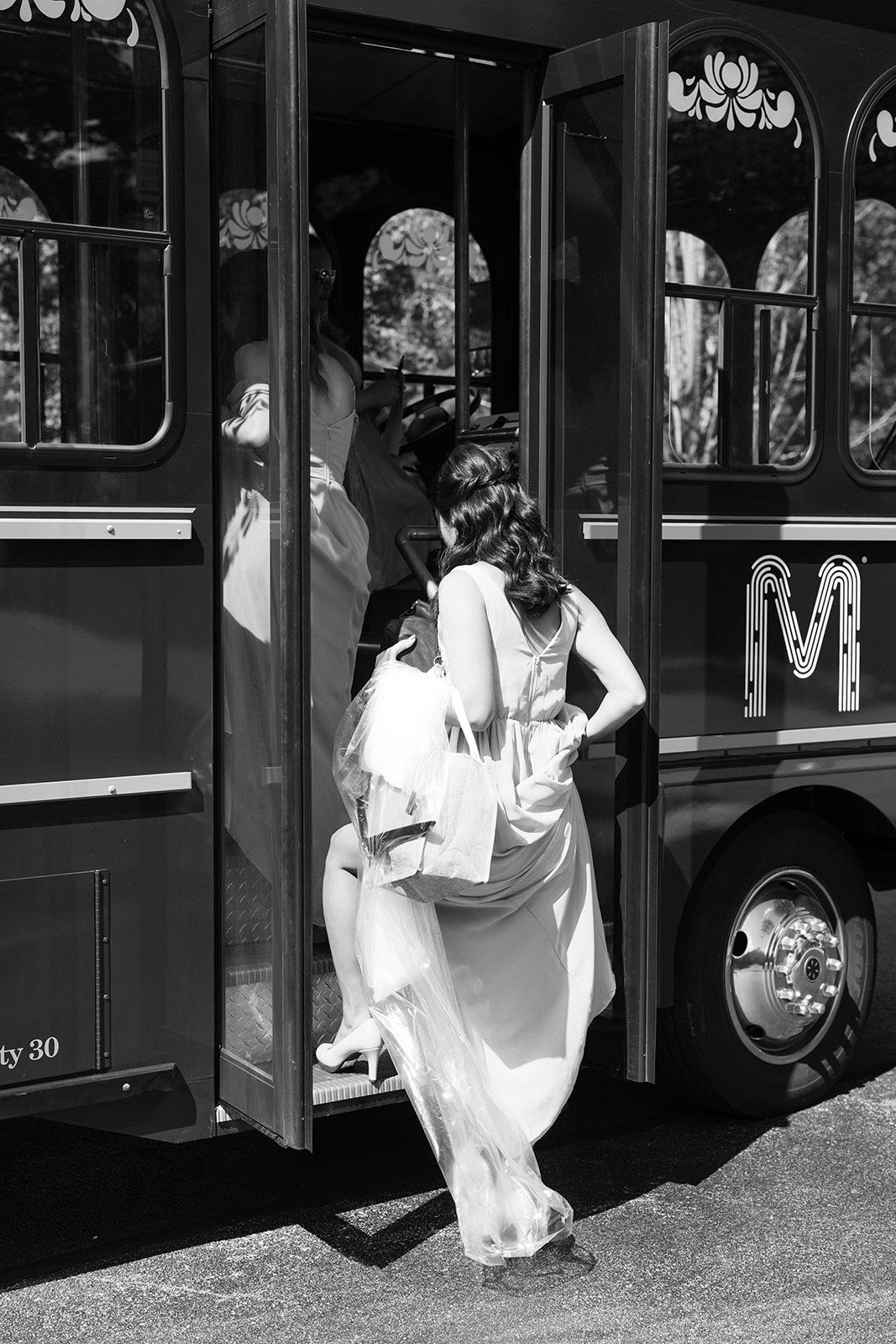 Stunning bride and bridesmaids enter their trolley during their dreamy Boston wedding day