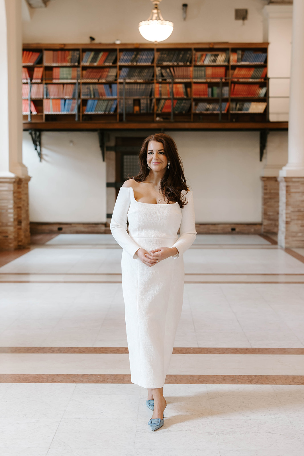 Beautiful bride poses in the Boston public library on her wedding day!
