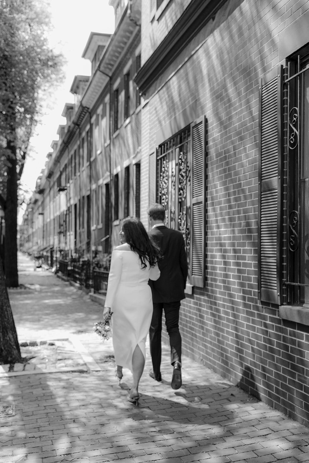 Beautiful bride and groom walk on the streets together after their dreamy Boston wedding day!