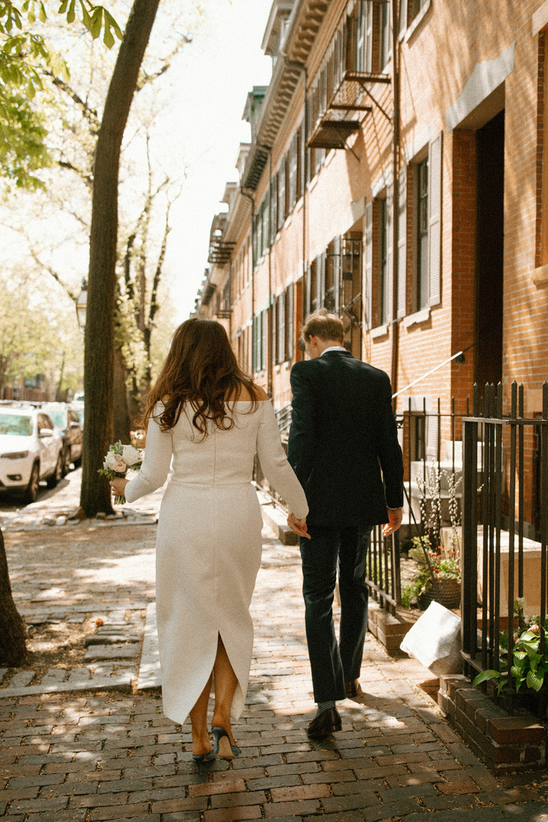 Beautiful bride and groom walk on the streets together after their dreamy Boston wedding day!