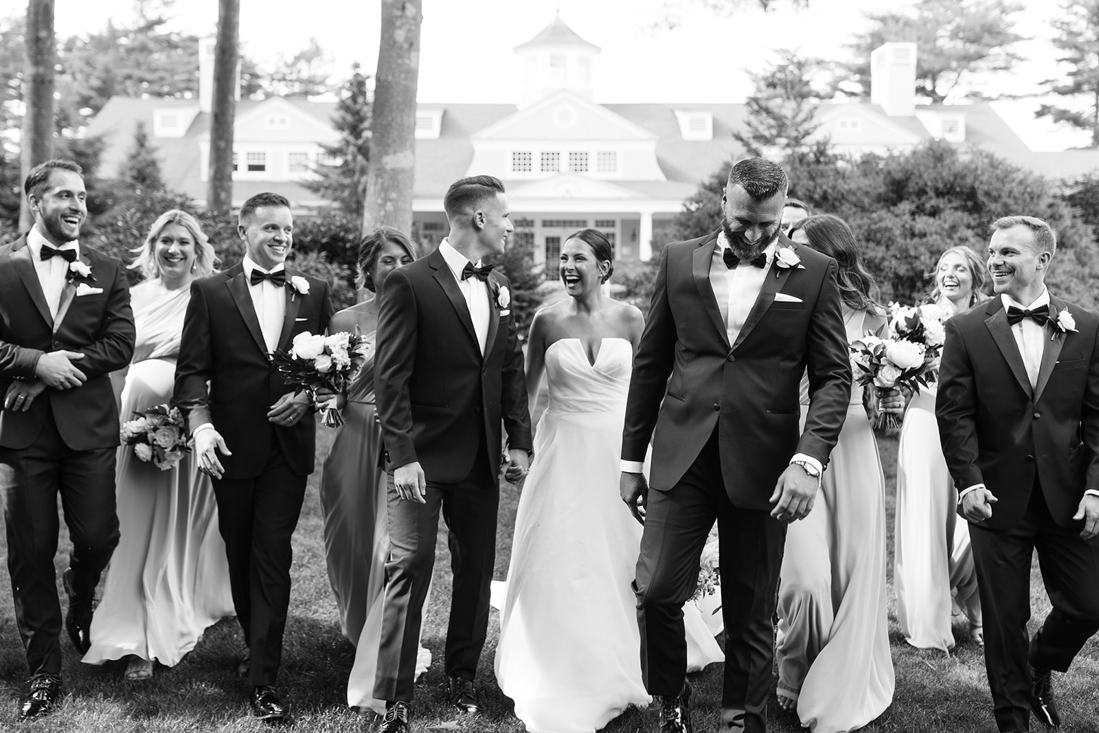 bridal party laughing in front of wedding venue in plymouth