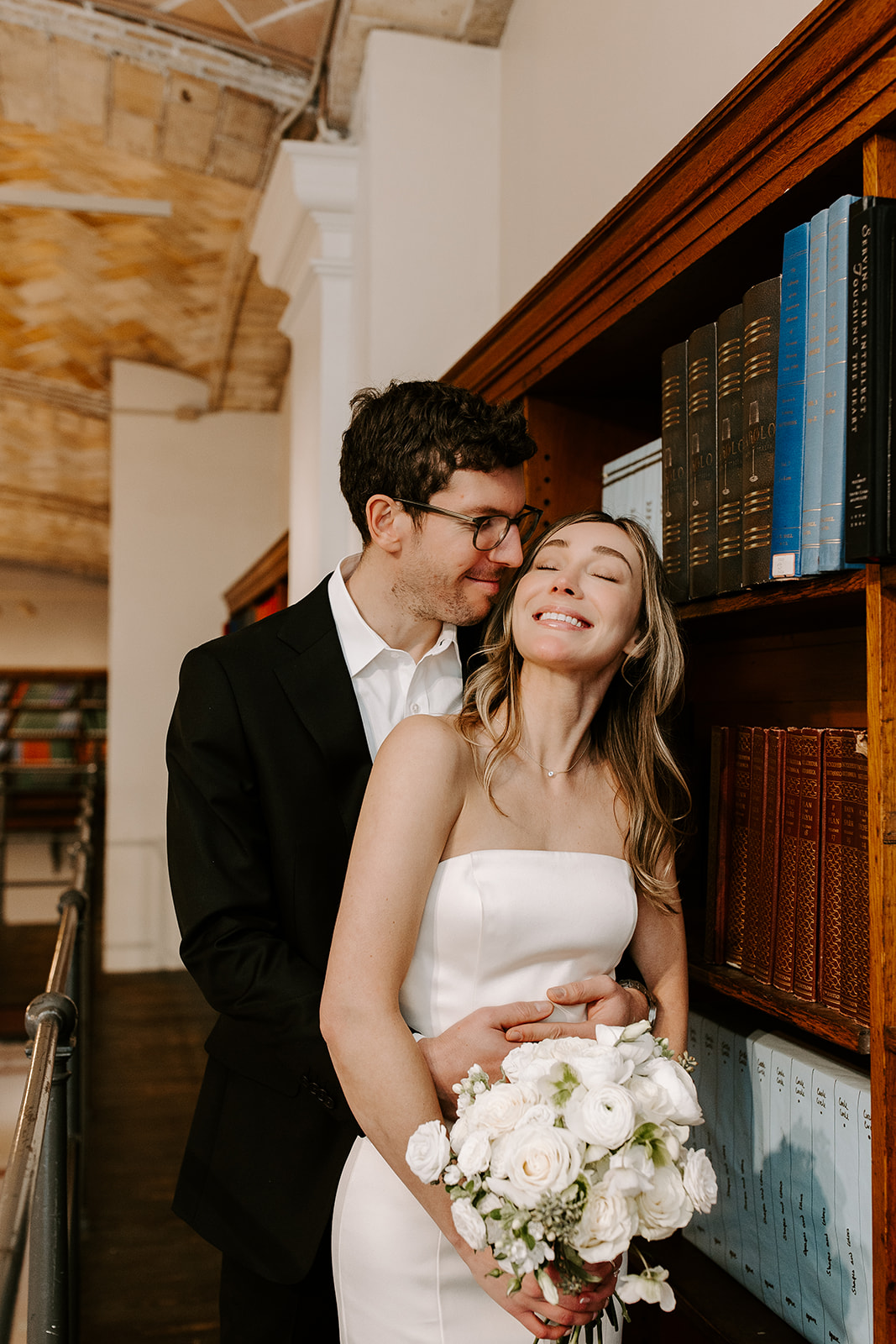Beautiful bride and groom pose together after their stunning Boston public library elopement