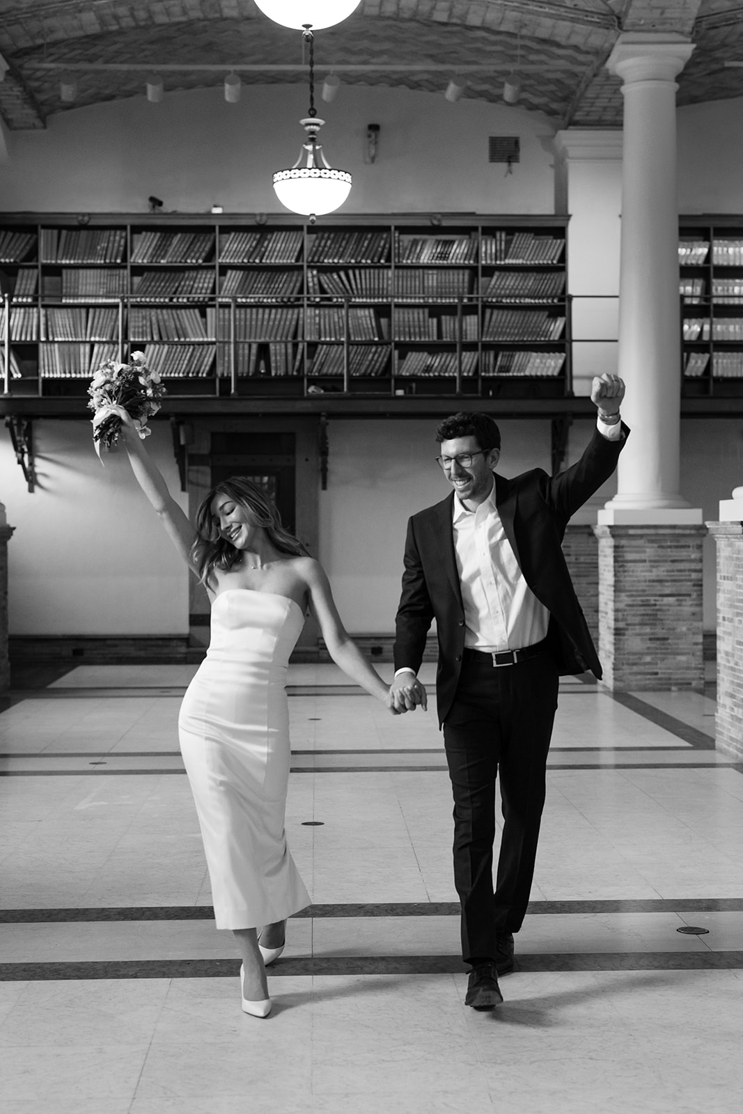 Stunning couple pose in the Boston public library after their dreamy winter elopement